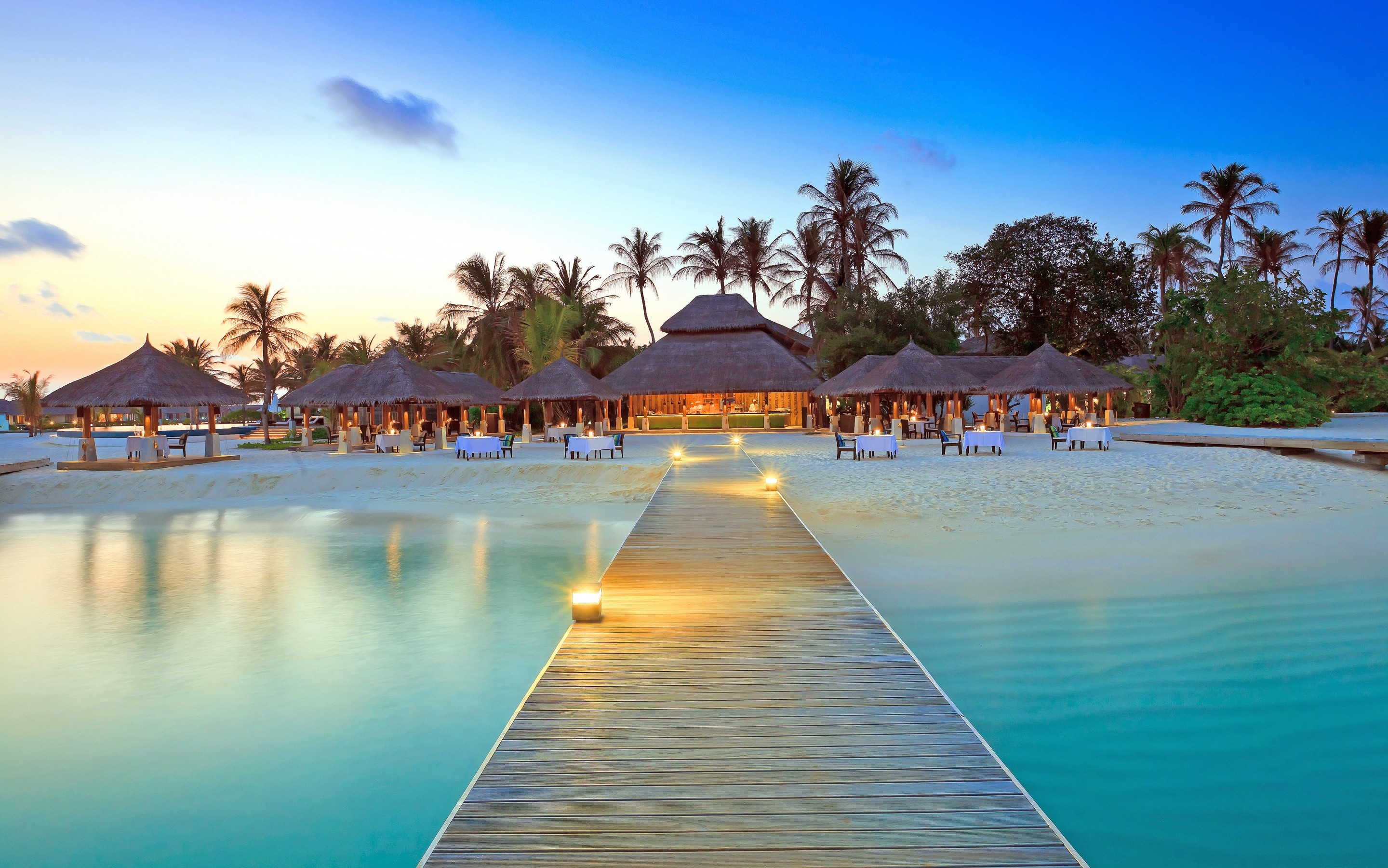 General 2880x1800 dock island beach palm trees hotel Maldives restaurant resort pier sky sunlight tropical jetty lights clouds table chair sand