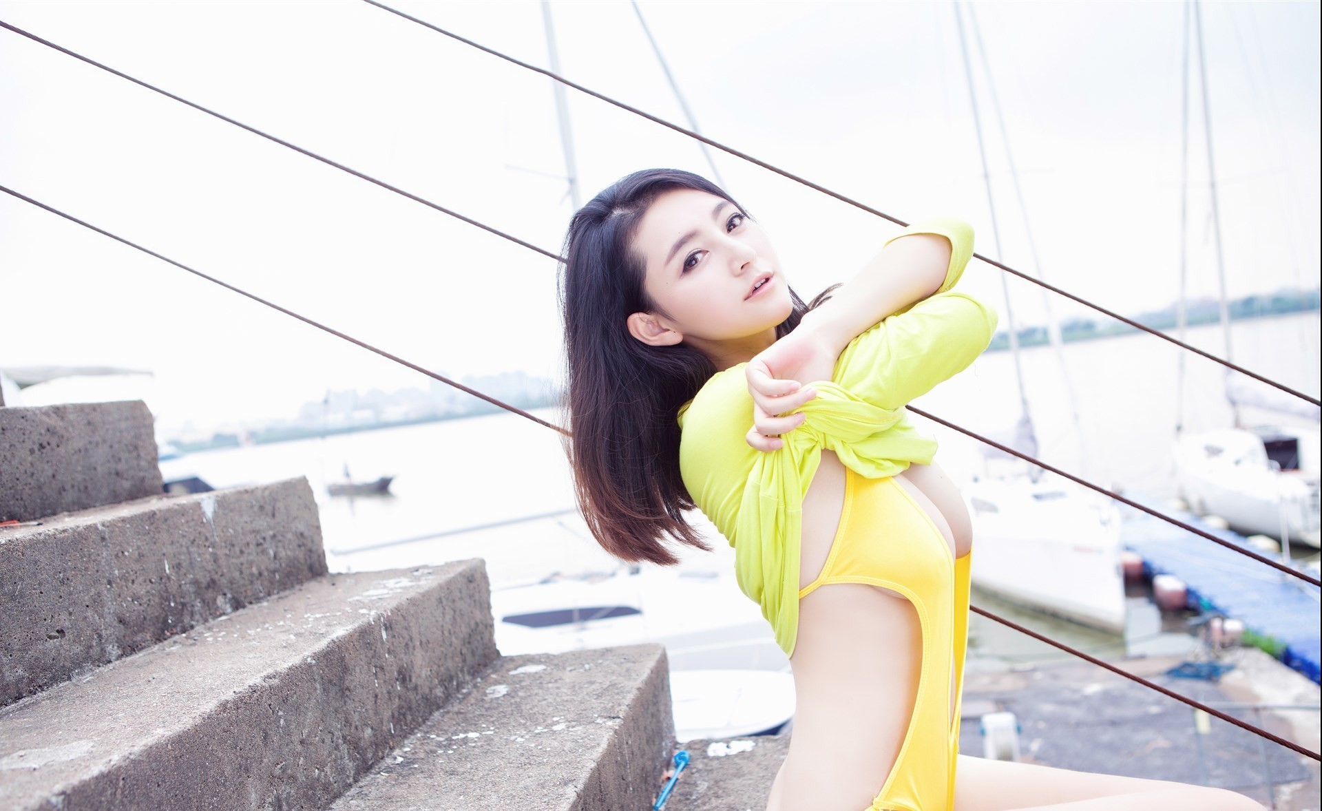 People 1920x1178 Asian women model brunette one-piece swimsuit brown eyes sitting stairs looking at viewer undressing boobs yellow clothing long hair women outdoors