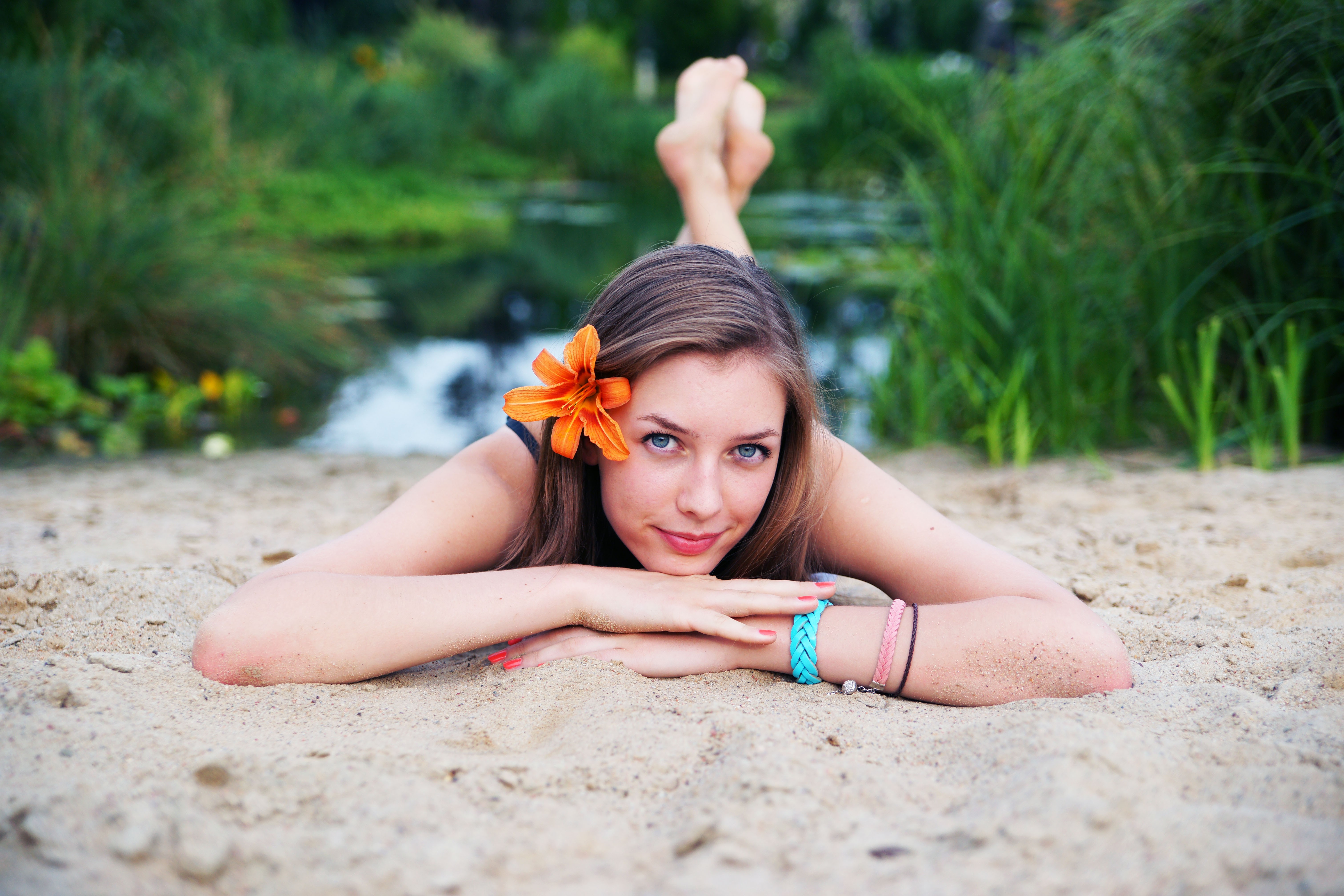 People 6048x4032 women women outdoors blue eyes sand model looking at viewer outdoors painted nails red nails flower in hair legs up brunette