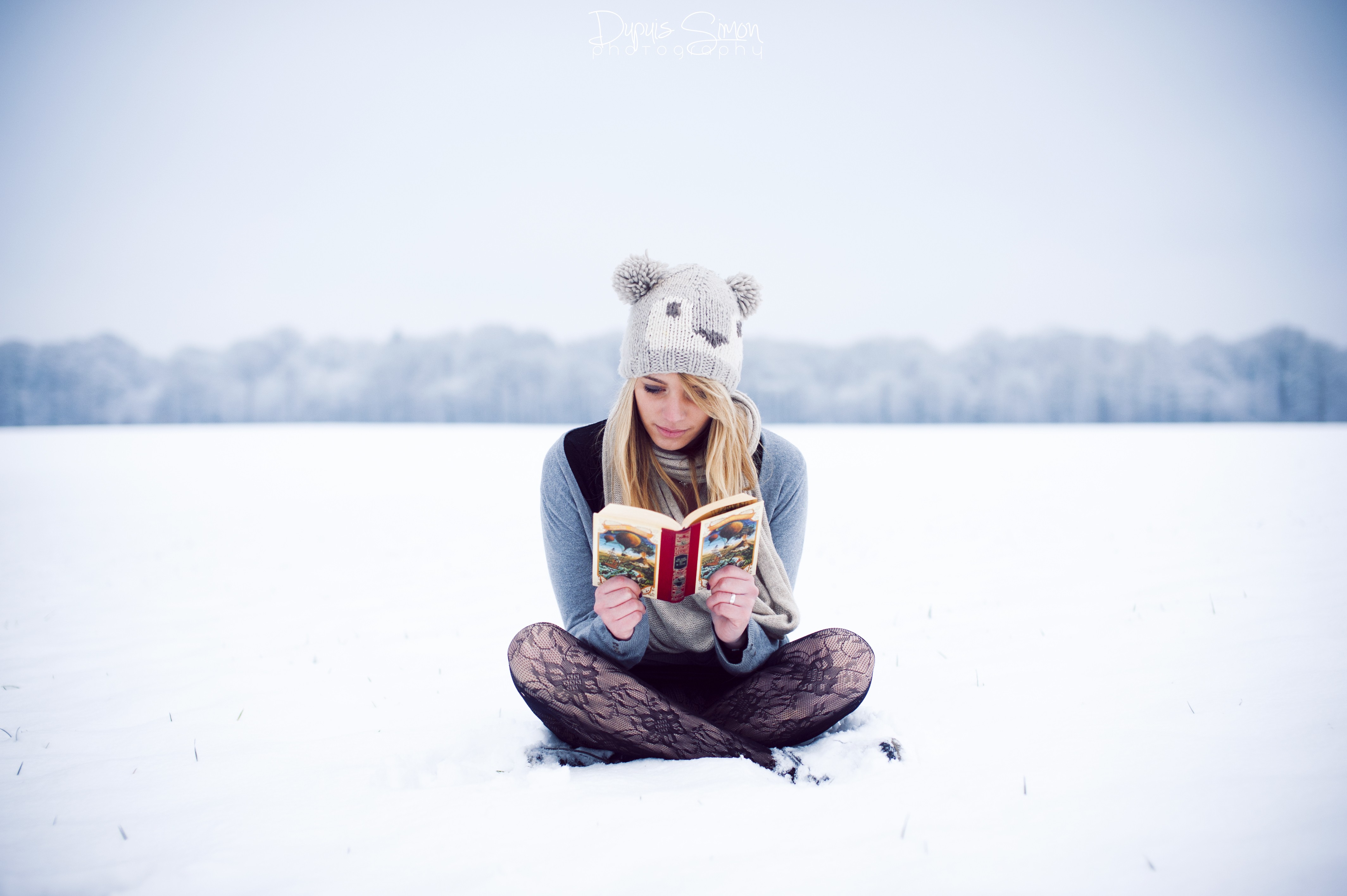 People 4256x2832 women winter women outdoors pantyhose sitting blonde long hair women with hats reading books cold ice outdoors legs crossed wool cap hat landscape