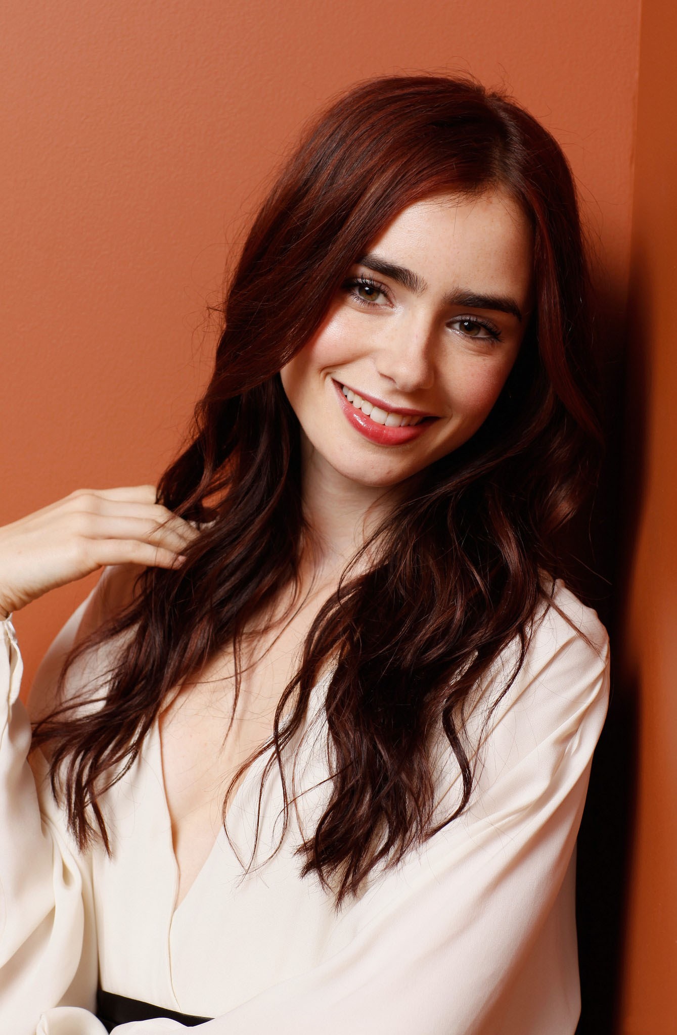 People 1339x2048 Lily Collins British British women British model women actress model orange background redhead dyed hair long hair women indoors indoors smiling red lipstick portrait display simple background