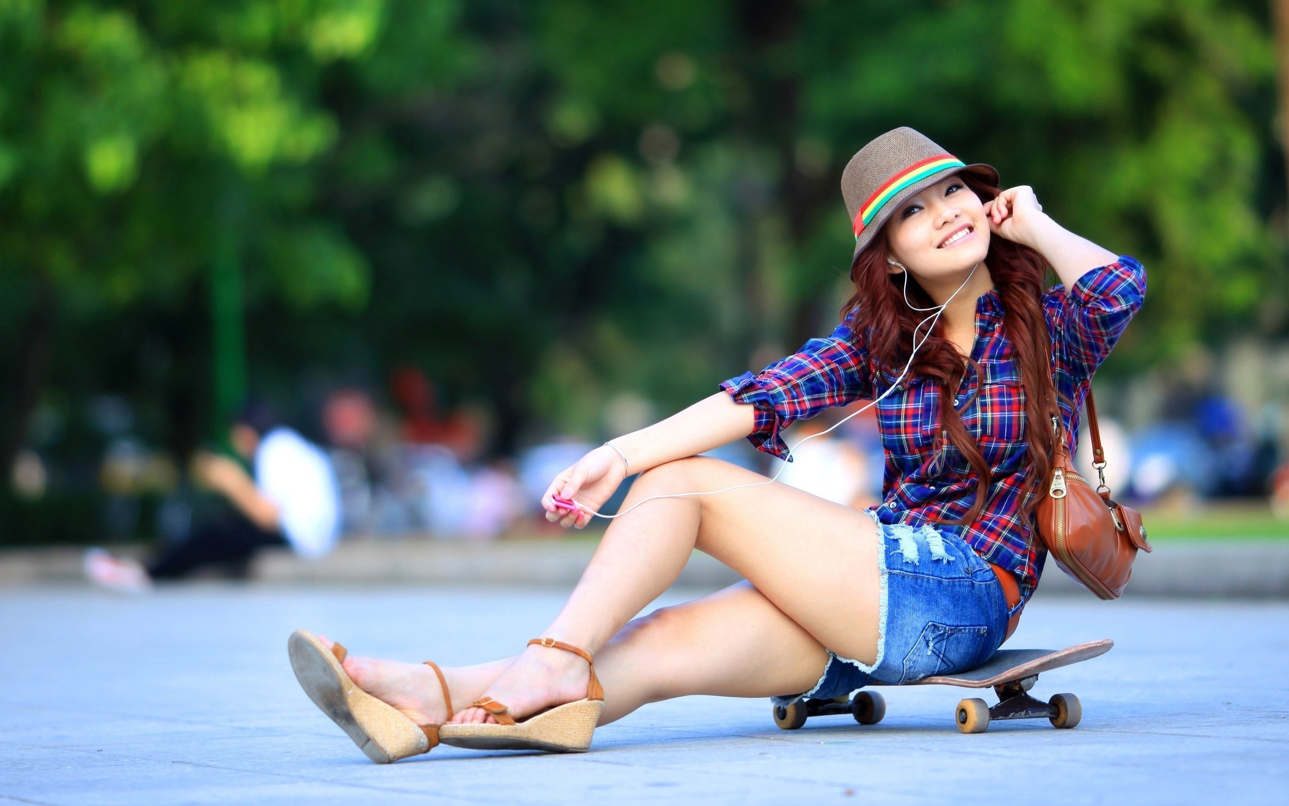 People 2560x1600 women jean shorts shorts hat skateboard shirt sitting looking at viewer earphones Asian smiling sandals legs urban women with hats wedge shoes plaid shirt dyed hair handbags