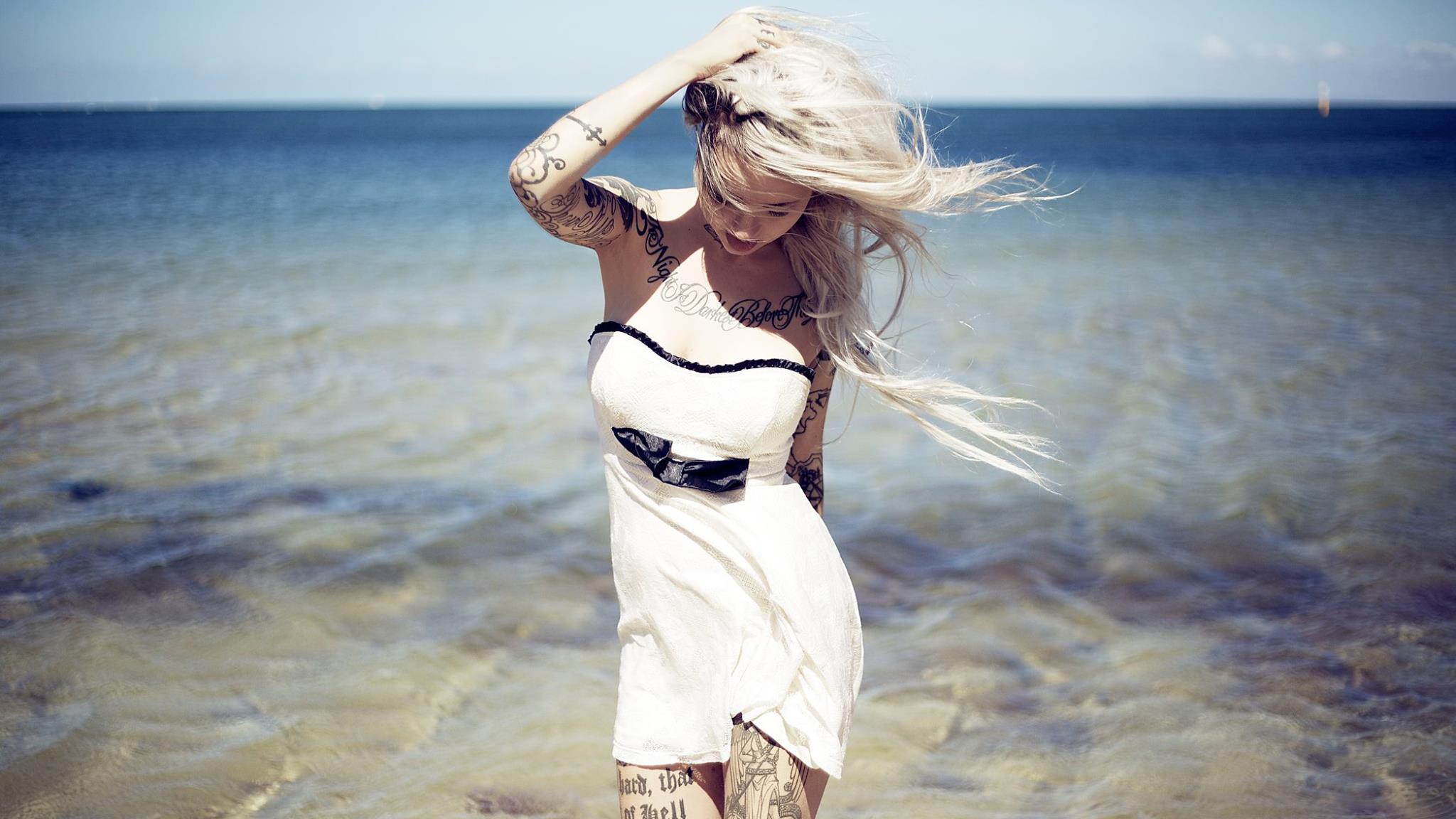 People 2048x1152 Sara Fabel blonde tattoo women model women outdoors outdoors standing windy inked girls water