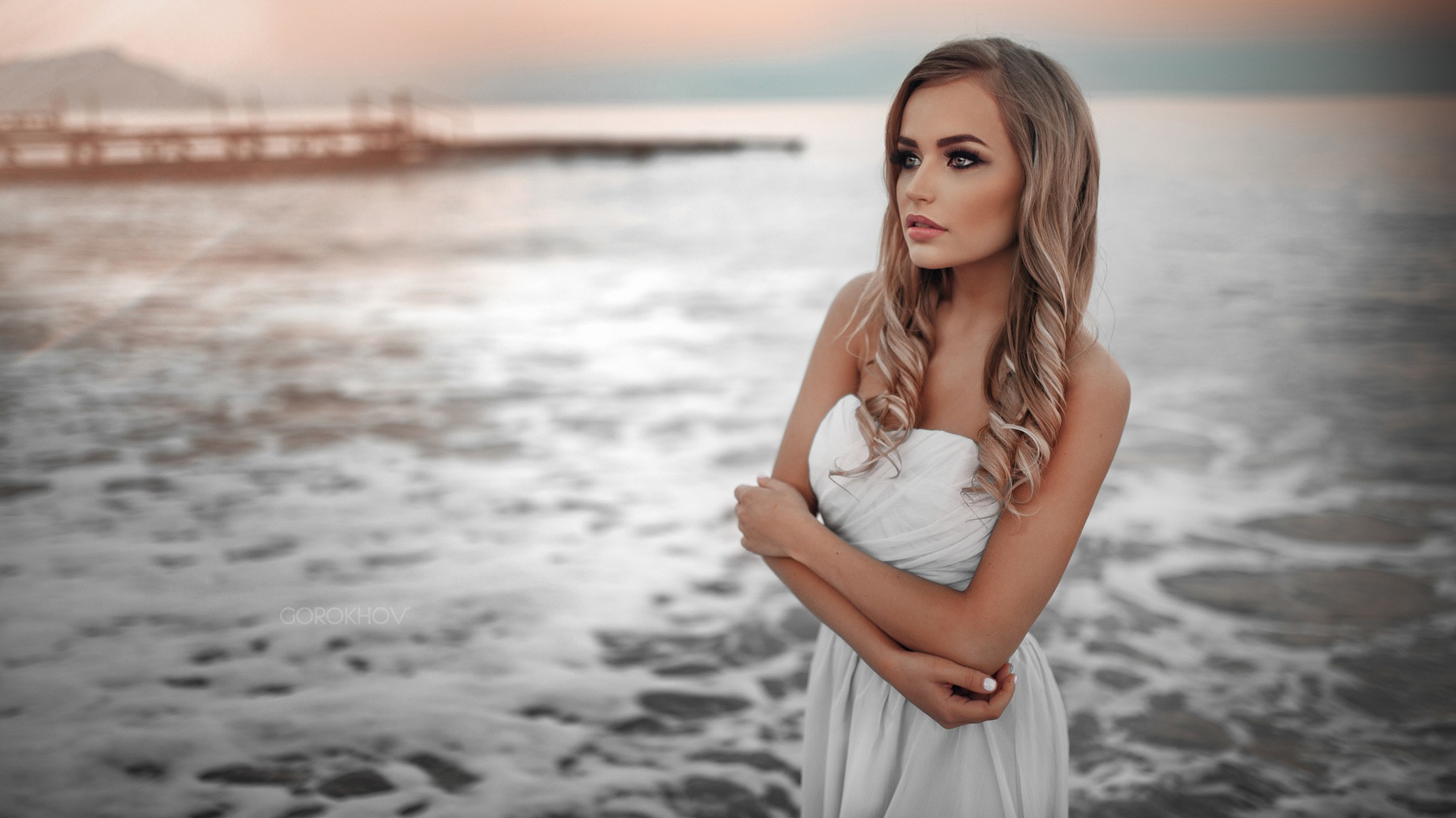 People 2048x1152 women blonde white dress sea looking away Maria Puchnina looking into the distance Ivan Gorokhov women on beach strapless dress white nails model women outdoors gray eyes arms crossed makeup