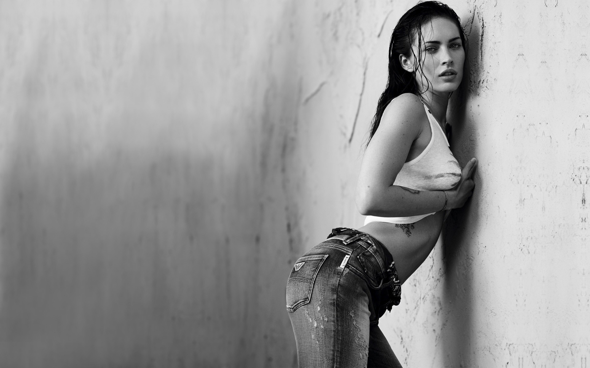 People 1920x1200 Megan Fox women brunette actress jeans ass monochrome American women parted lips belly inked girls wall looking at viewer celebrity