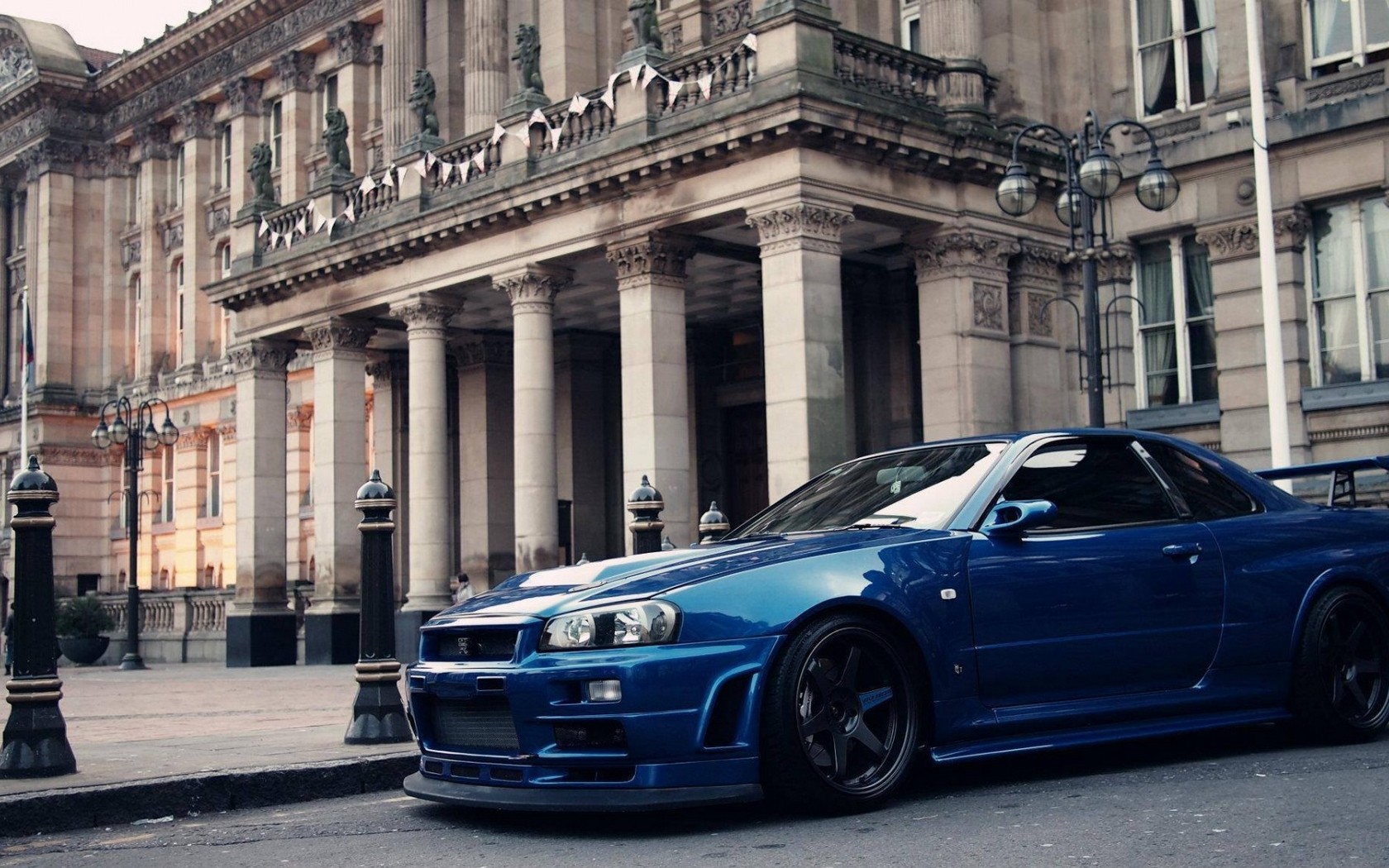 General 1680x1050 car blue cars architecture pillar reflection vehicle Nissan Skyline R34 Nissan Nissan Skyline front angle view
