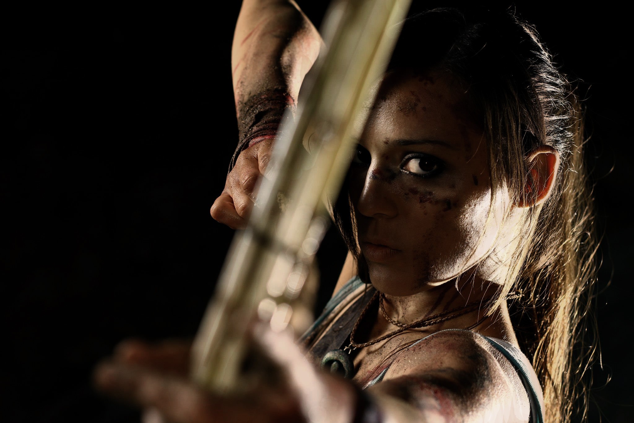 People 2048x1366 Tomb Raider cosplay women simple background black background aiming bow at gunpoint Lara Croft (Tomb Raider) bow and arrow model face closeup looking at viewer video games video game girls video game characters dirt