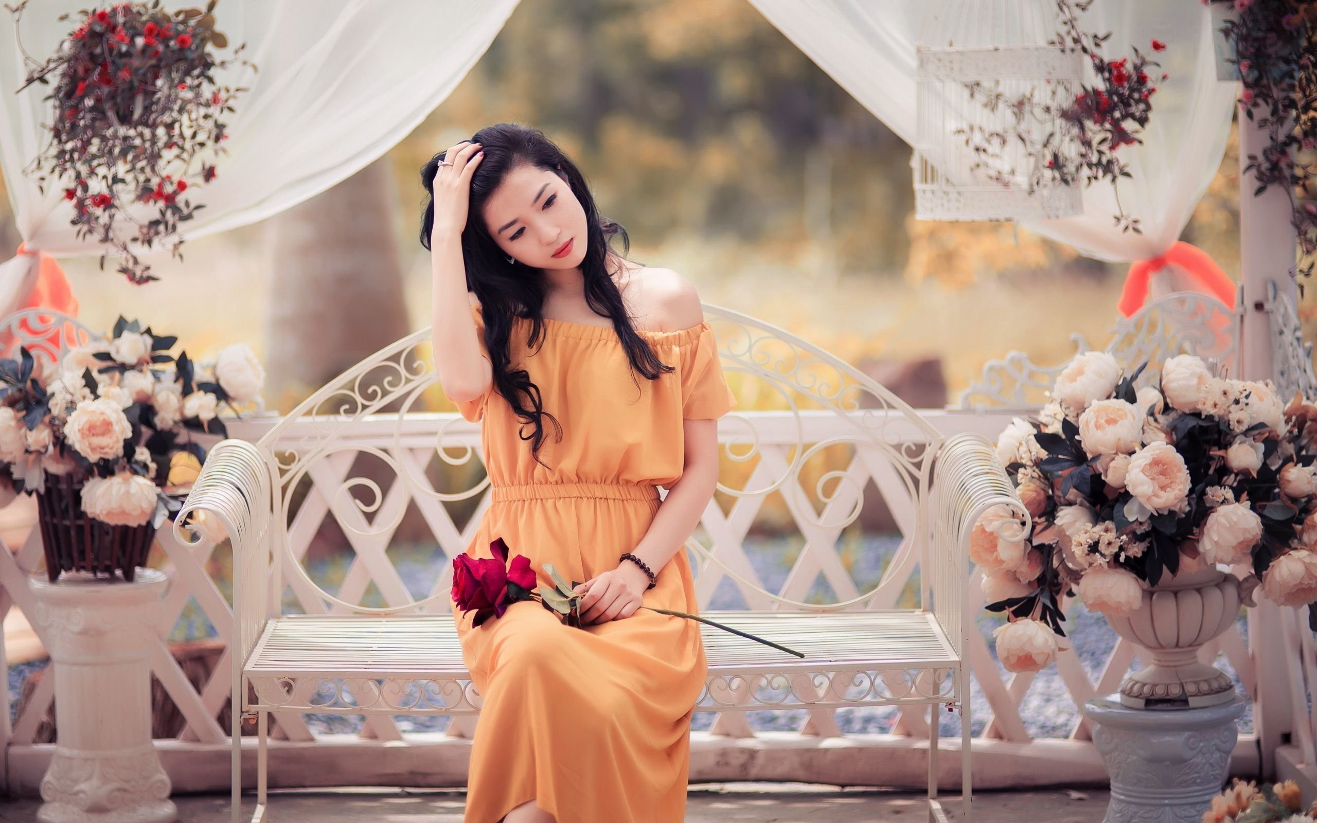 People 2560x1600 women model brunette long hair women outdoors nature trees Asian orange dress sitting flowers bench rose hands in hair red lipstick curtains