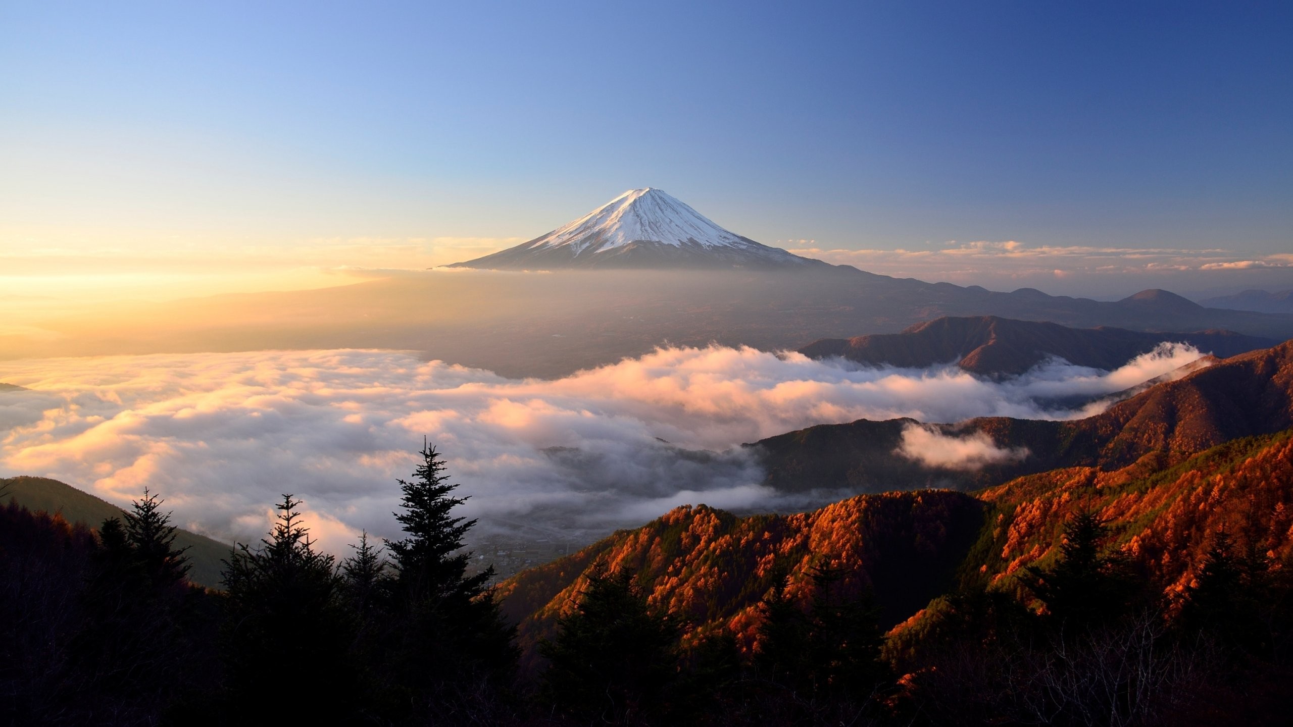 General 2560x1440 Mount Fuji clouds trees sky nature landscape mist sunlight Japan sunrise mountains Asia snowy peak snowy mountain volcano