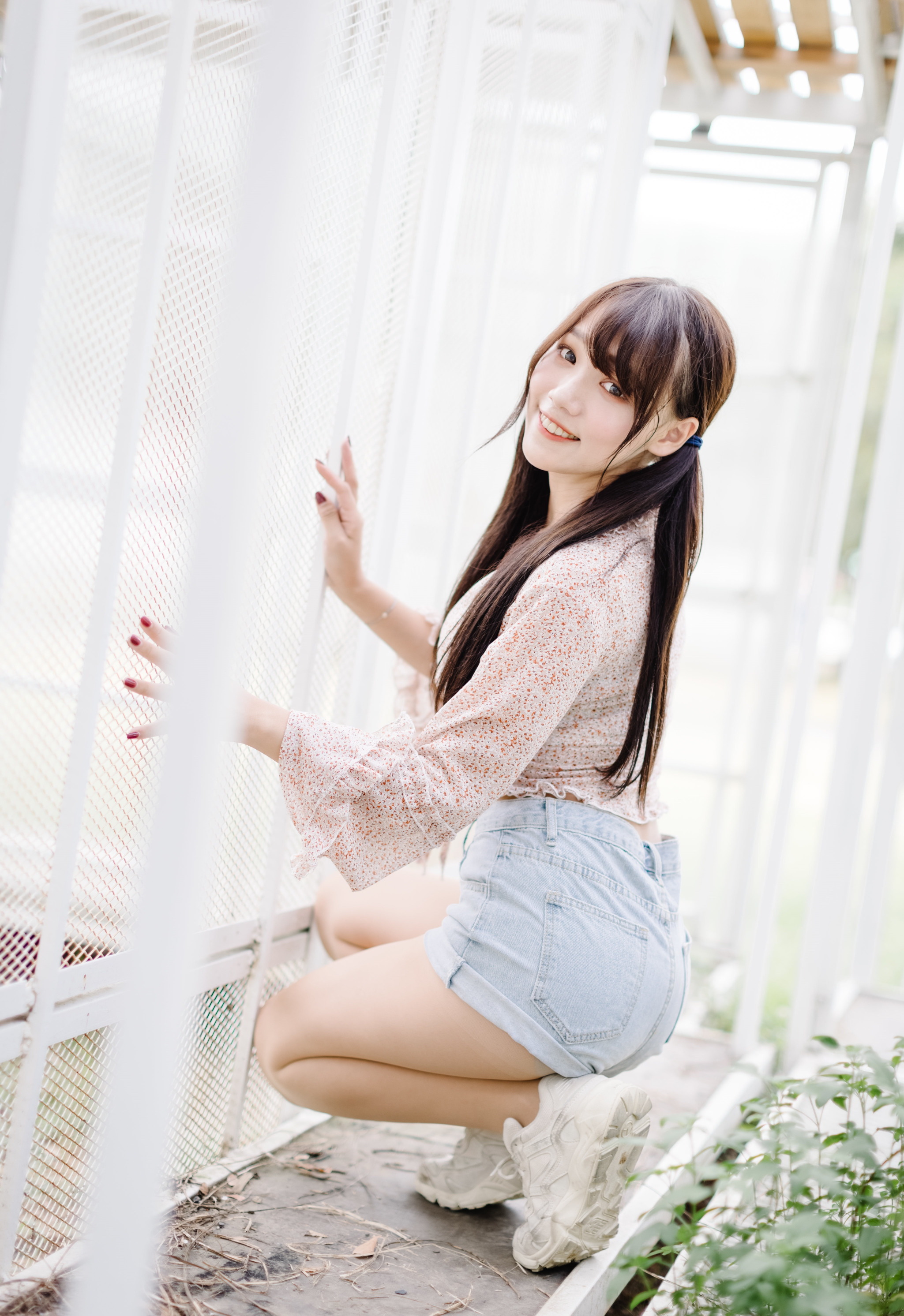 People 2049x2984 Asian model women long hair dark hair sneakers legs pantyhose jean shorts short shorts high waisted shorts painted nails smiling red lipstick squatting looking at viewer twintails indoors women indoors