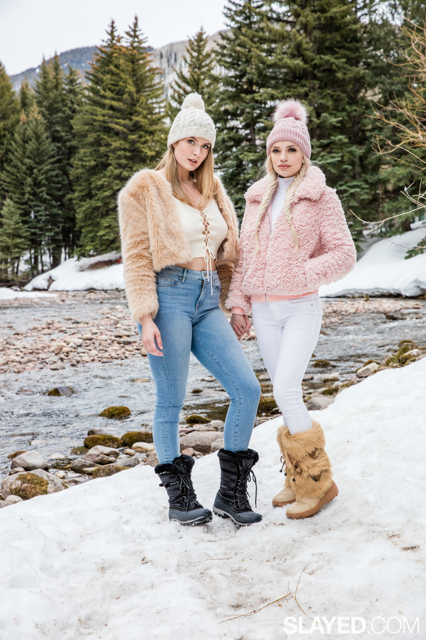 People 853x1280 Alex Grey Mia Melano women Slayed snow two women knit hat fur coats jeans lace up top women outdoors pine trees snow boots blonde watermarked portrait display American women