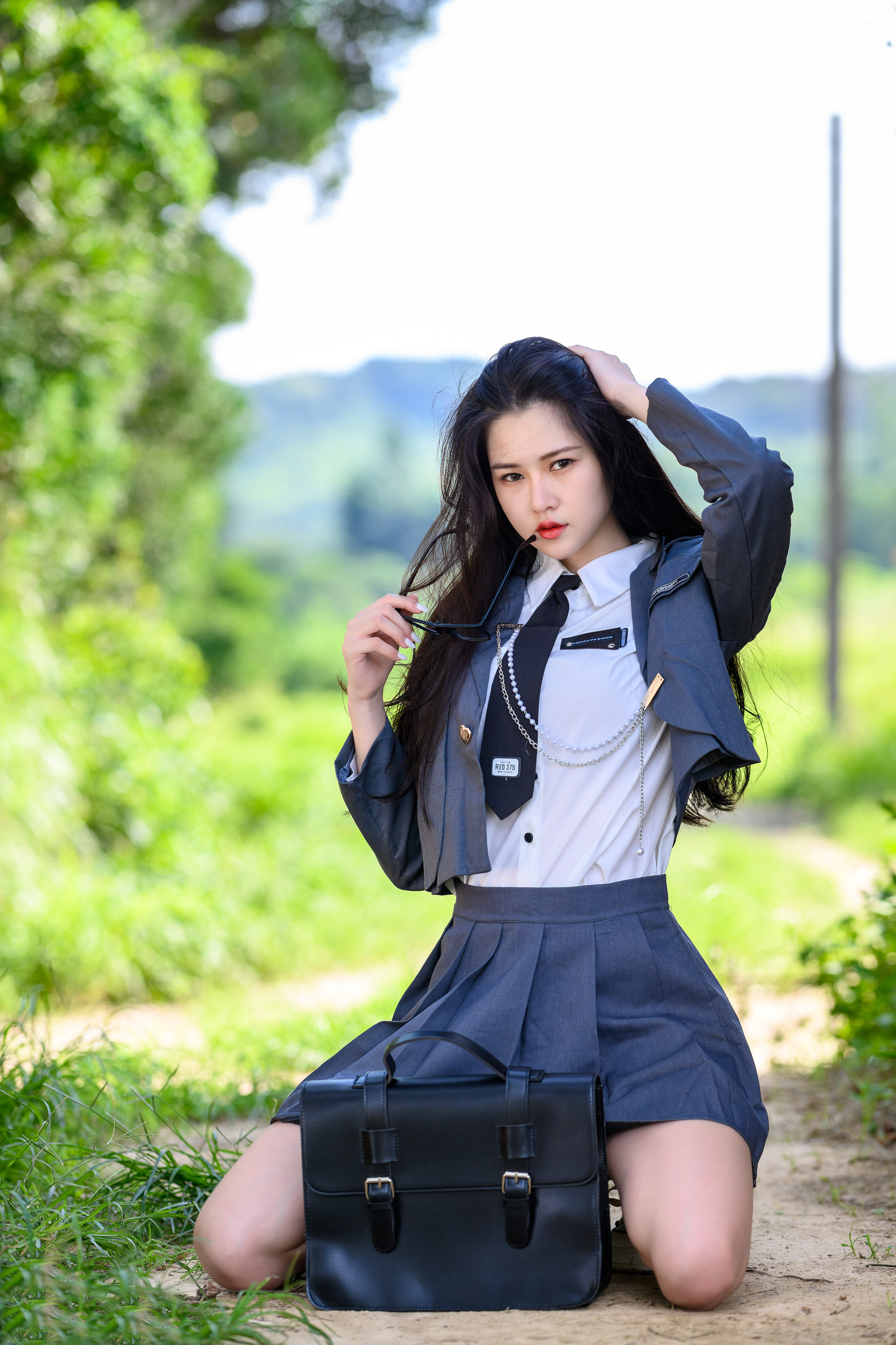 People 2560x3841 Asian model women long hair dark hair depth of field school uniform kneeling grass bushes trees glasses tie utility pole