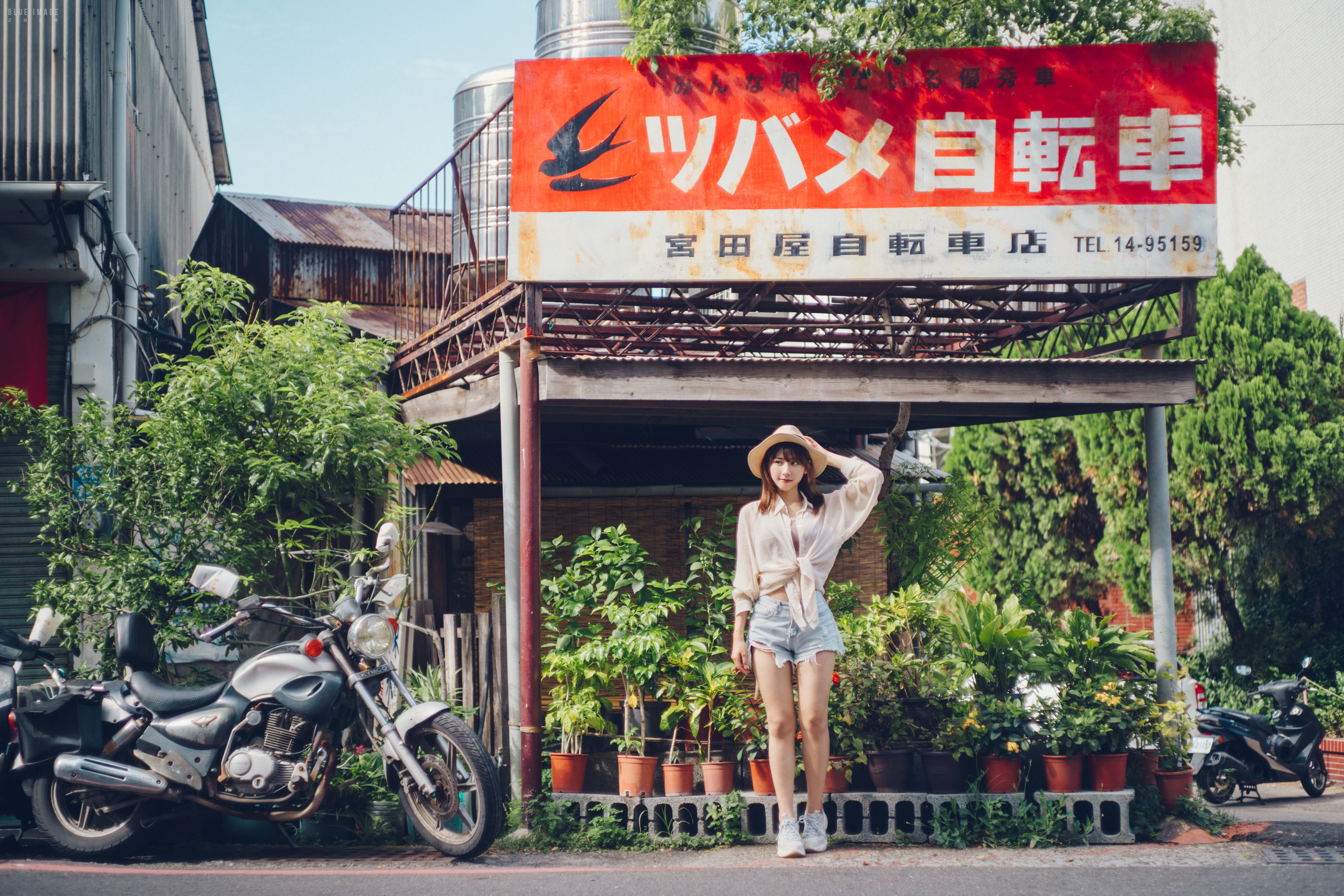 People 3840x2560 women model Asian brunette women with hats looking away smiling shirt tied top jean shorts short shorts frontal view torn clothes sneakers standing plants motorcycle street outdoors women outdoors