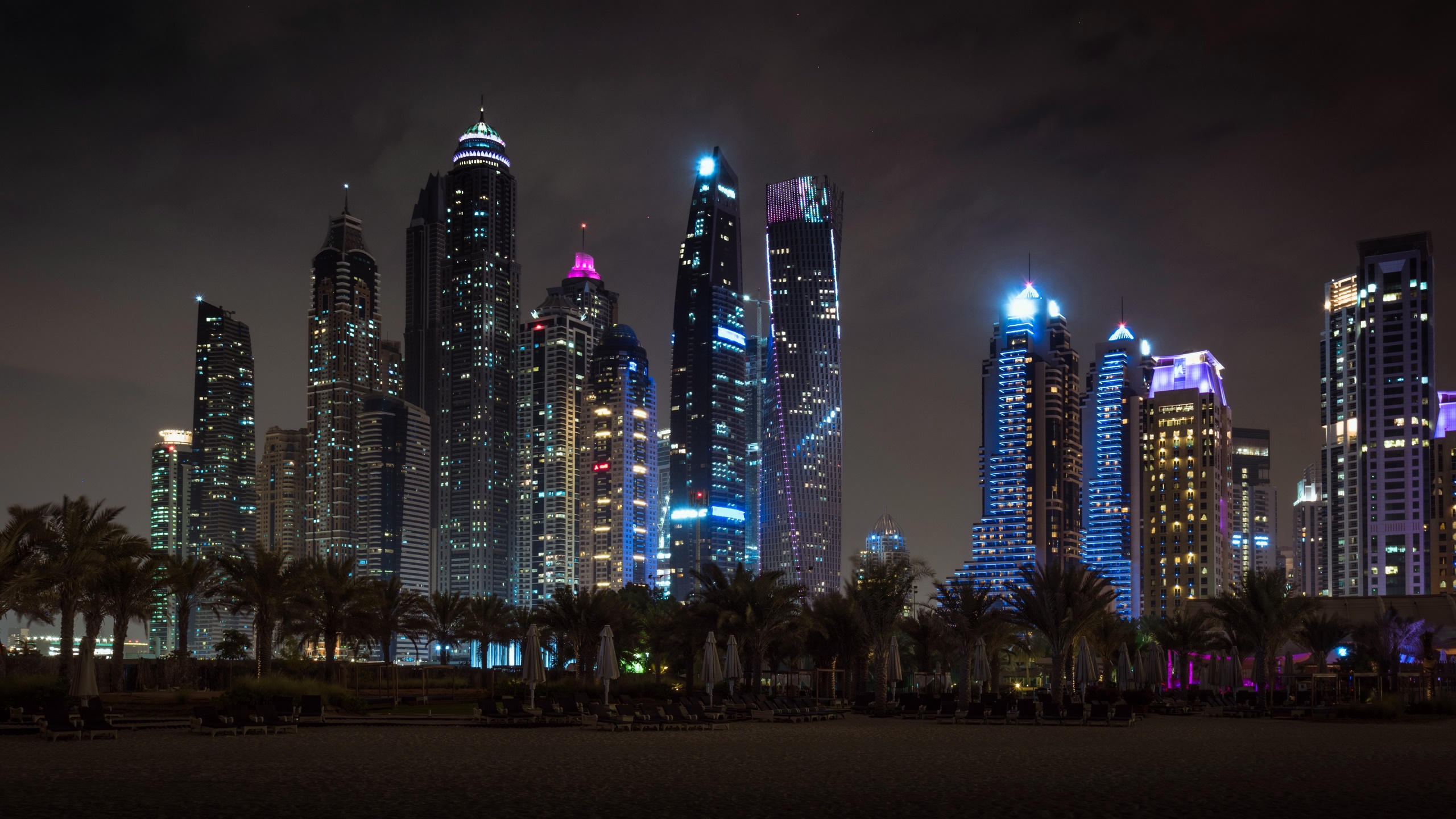 General 2560x1440 city lights cityscape Dubai night skyscraper building clouds palm trees beach