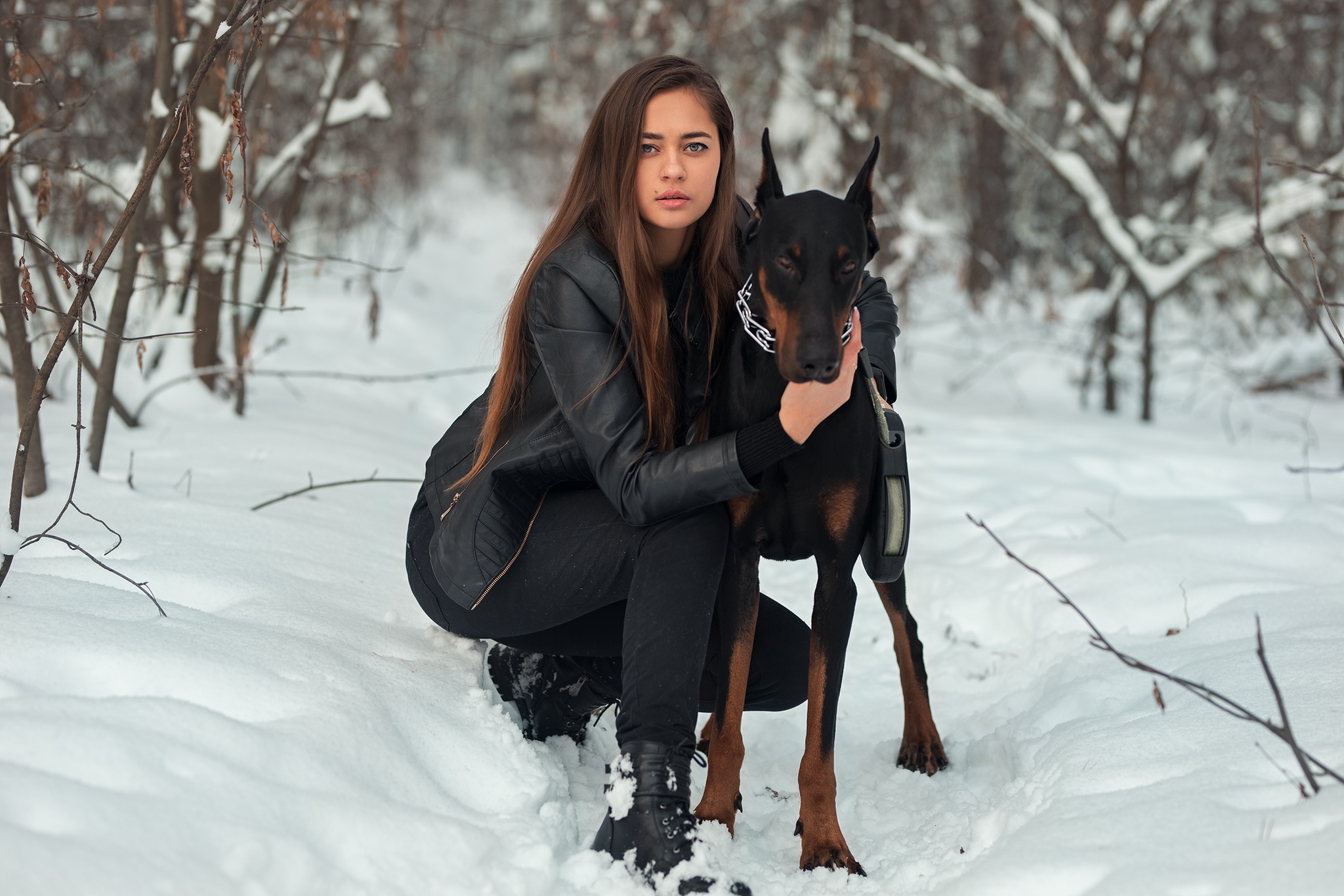 People 2048x1365 women model brunette long hair looking at viewer leather jacket jacket black jackets jeans boots squatting dog pet animals Doberman Pinscher snow outdoors women outdoors Dmitry Shulgin black clothing blue eyes women with dogs kneeling
