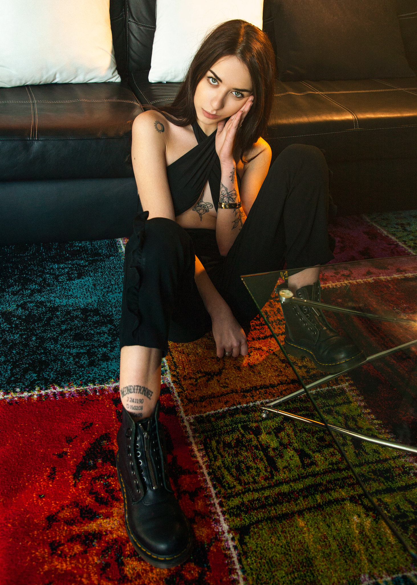 People 1463x2048 Hill Hart women brunette long hair straight hair looking at viewer hand on face tattoo bare shoulders black clothing pants boots carpet colorful Doc Martens