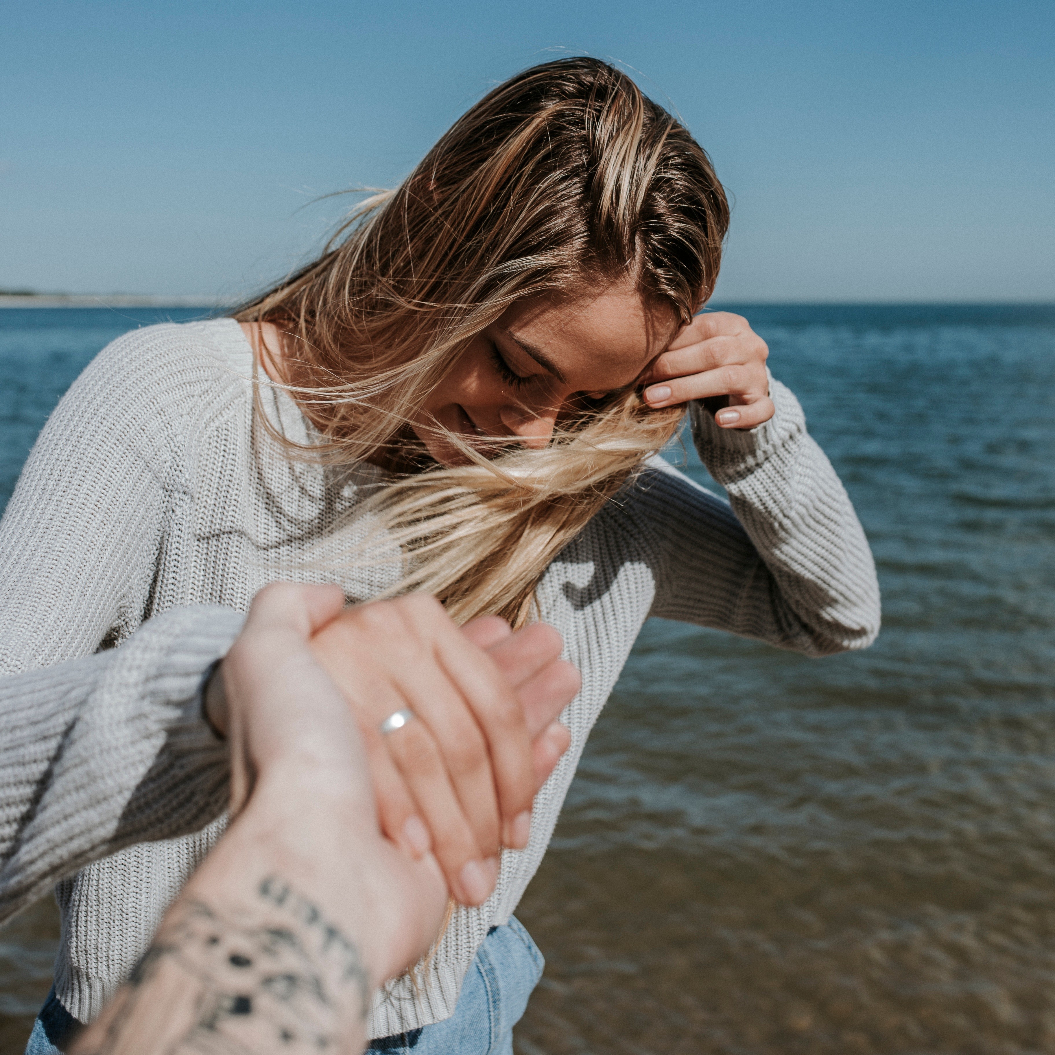 People 3648x3648 photography blonde sweater beach rings windy hands hair blowing in the wind couple holding hands white sweater happy women on beach women POV