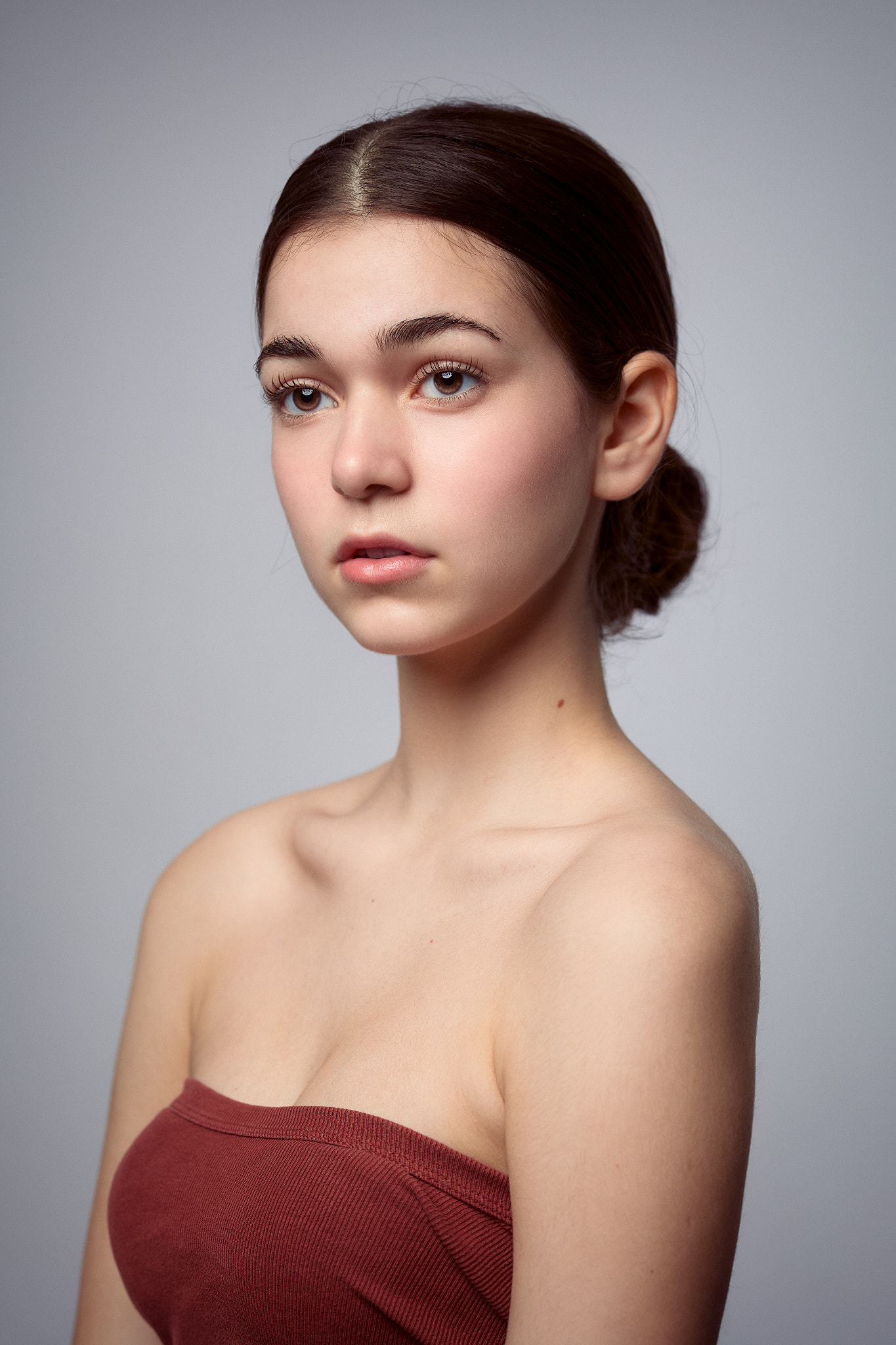 People 1365x2048 Dave Willems women portrait hairbun bare shoulders simple background model brunette brown eyes parted lips cleavage gray background studio