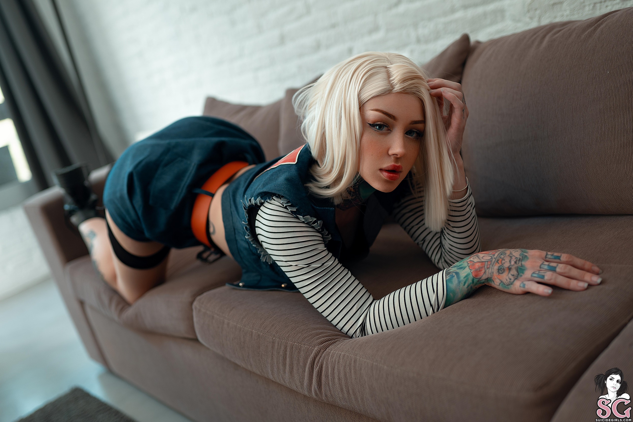 People 2490x1660 Raisie Suicide Girls blonde women model tattoo women indoors couch kneeling sensual gaze red lipstick face eyeliner looking at viewer watermarked whole body