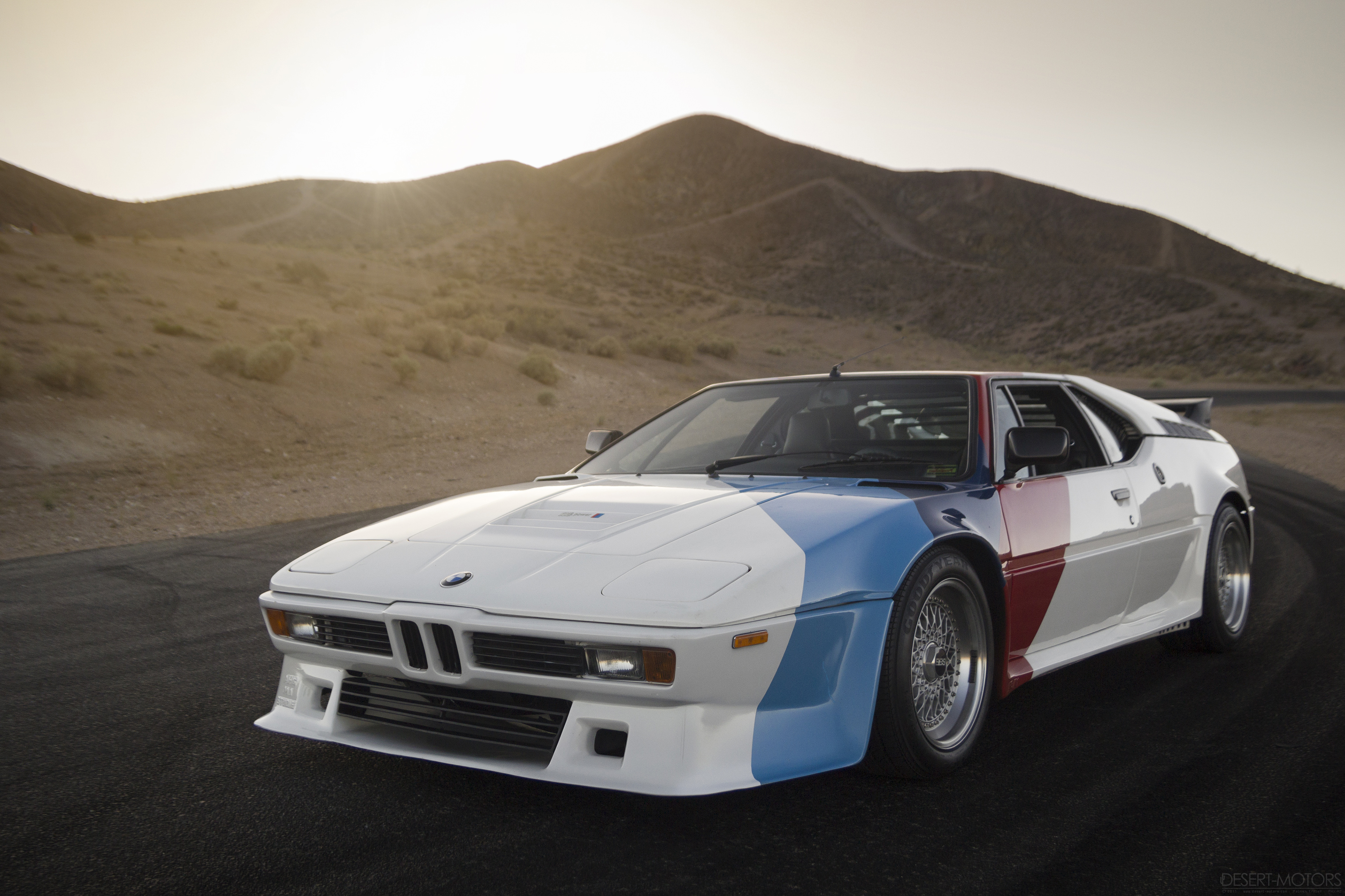 General 3840x2560 BMW M1 white cars race cars race tracks desert racing stripes pop-up headlights BMW German cars livery sunlight frontal view headlights hills watermarked vehicle car