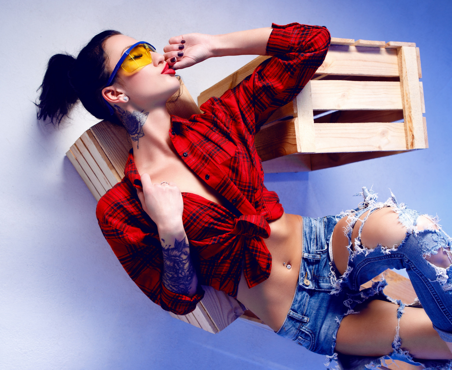 People 1566x1280 bare midriff torn jeans red shirt tattoo sleeve pierced navel thighs lying on back dark hair belly button closed eyes legs crossed lying down caressing glasses hairbun blue background belly model tattoo women open shirt