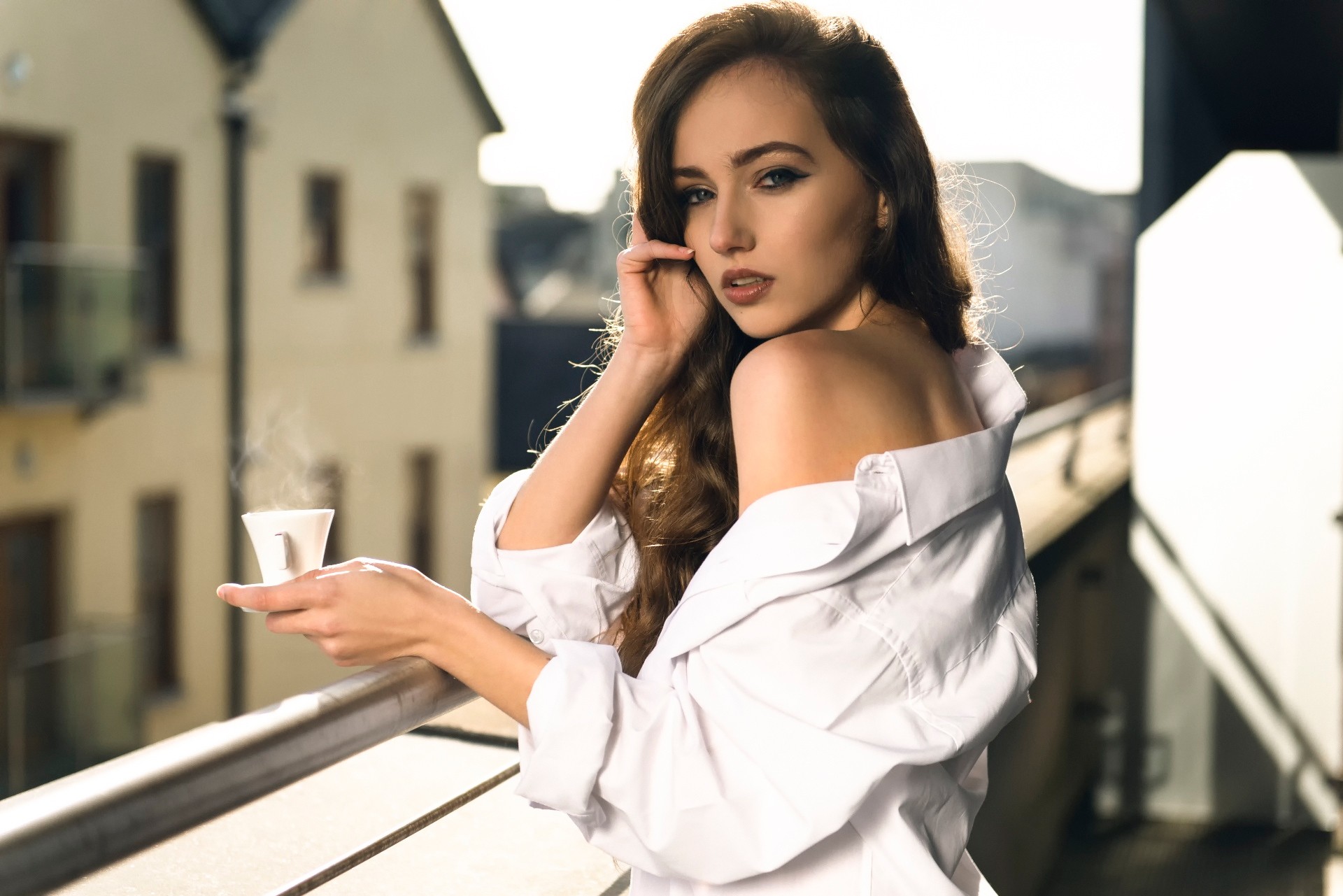 People 1920x1281 women brunette white shirt bare shoulders morning looking at viewer eyeliner blue eyes portrait open mouth balcony shirt glamour cup long hair makeup white clothing