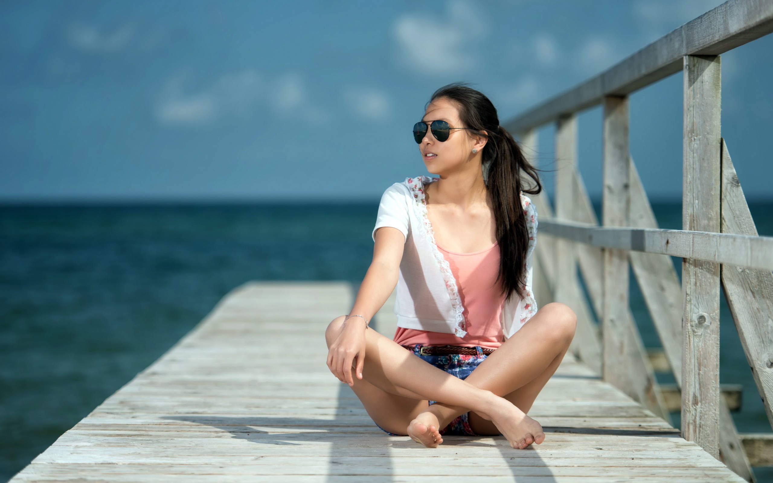 People 2560x1600 women brunette dock short shorts ponytail sitting sea Asian barefoot feet legs crossed sunglasses women outdoors model outdoors looking into the distance pier