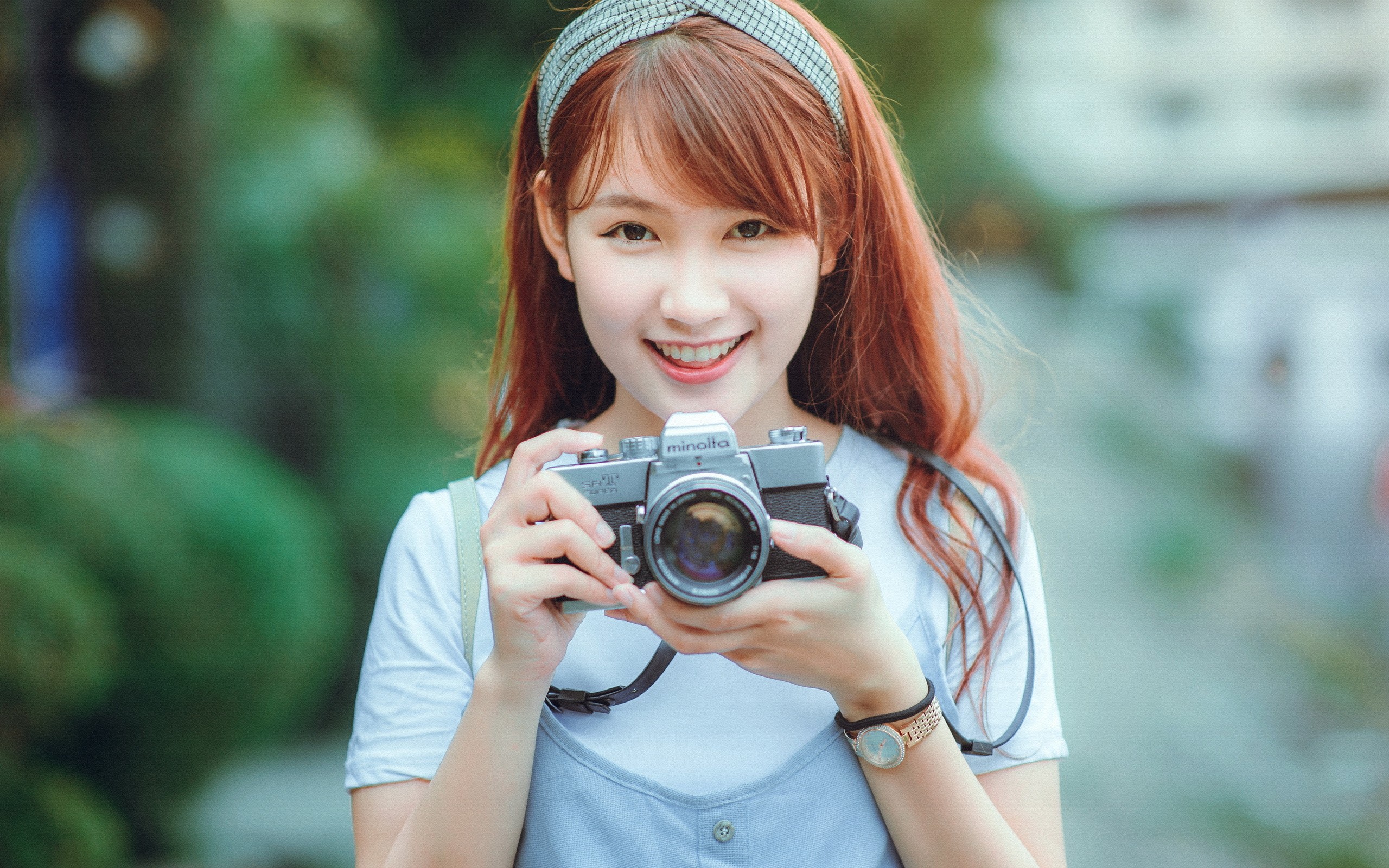 People 2560x1600 Asian camera women model redhead long hair brown eyes looking at viewer hairband smiling women outdoors Minolta wristwatch technology