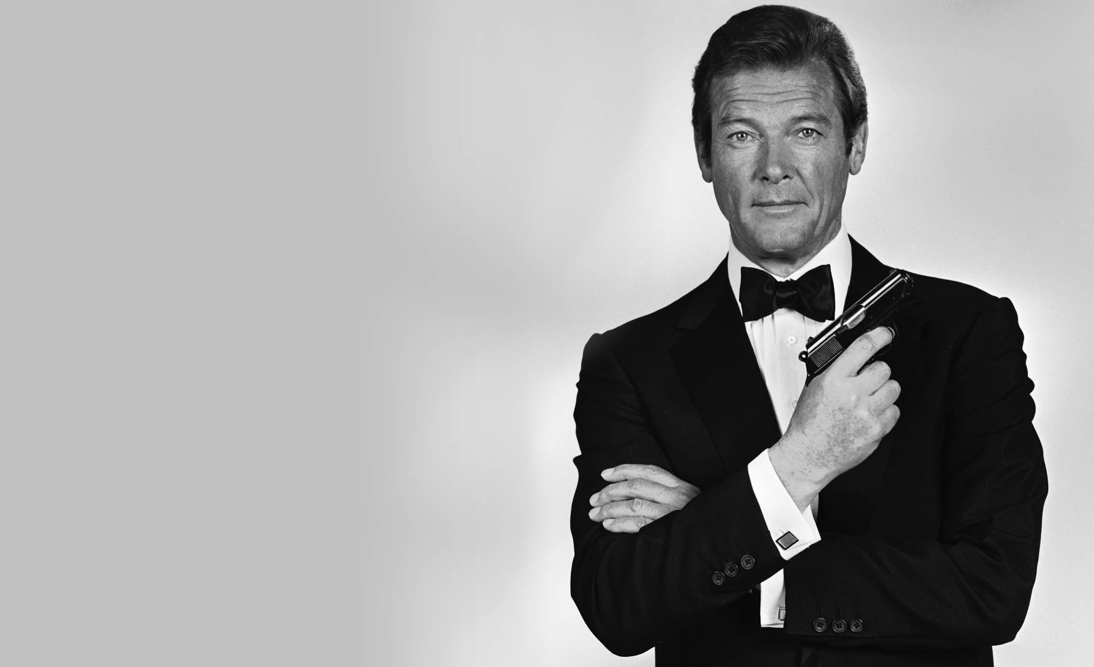 People 2250x1371 monochrome movies tuxedo James Bond Roger Moore actor men gun simple background