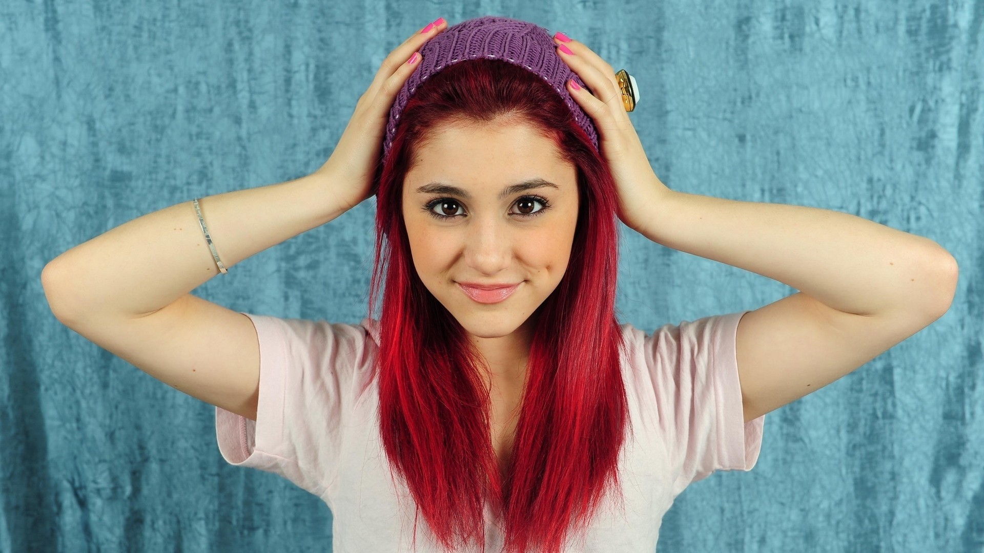 People 1920x1080 Ariana Grande redhead hands on head woolly hat women brown eyes knit hat smiling T-shirt looking at viewer long hair women indoors pink nails painted nails singer American women