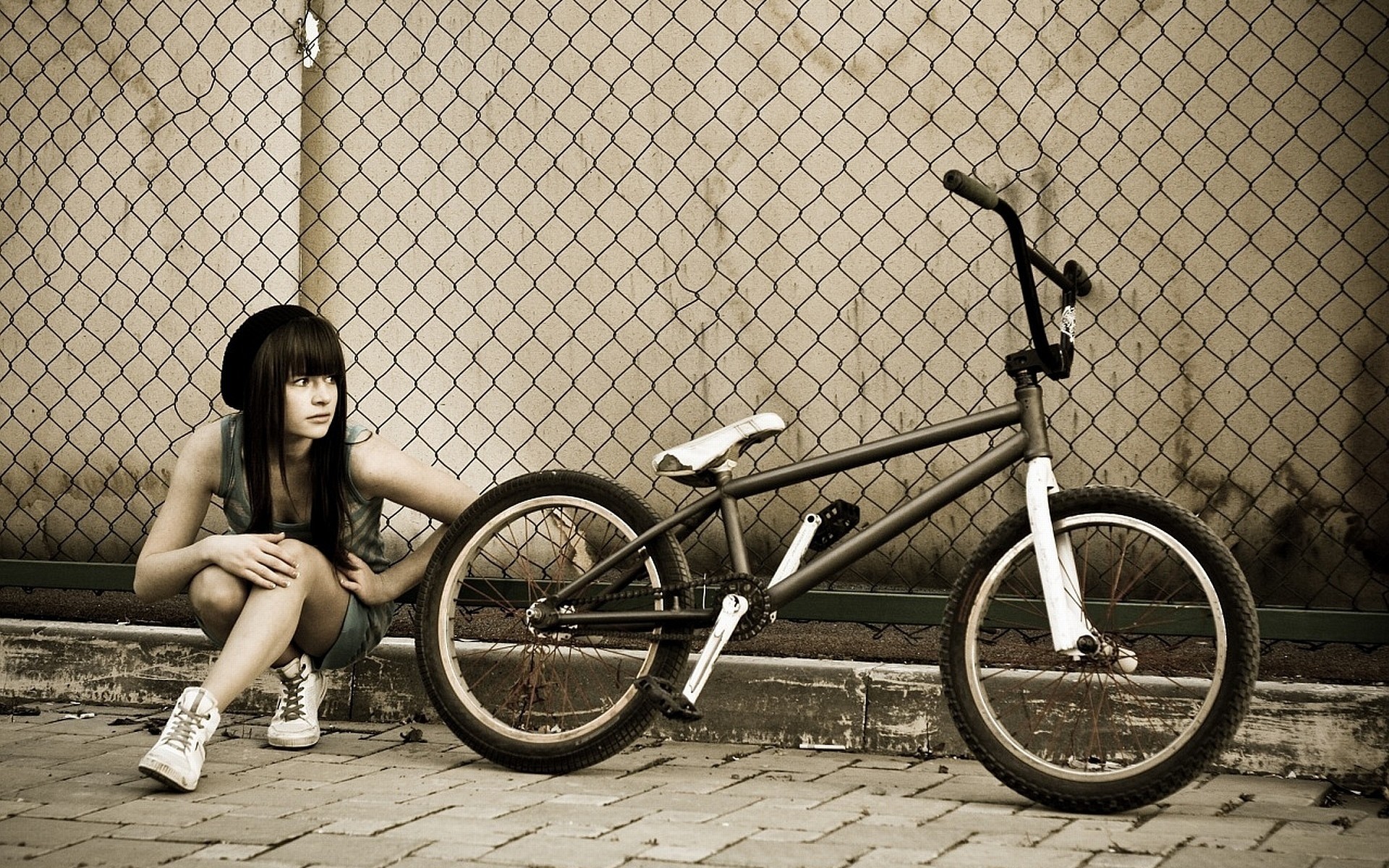 People 1920x1200 monochrome BMX low saturation women women outdoors women with bicycles brunette long hair squatting looking away waiting bicycle urban
