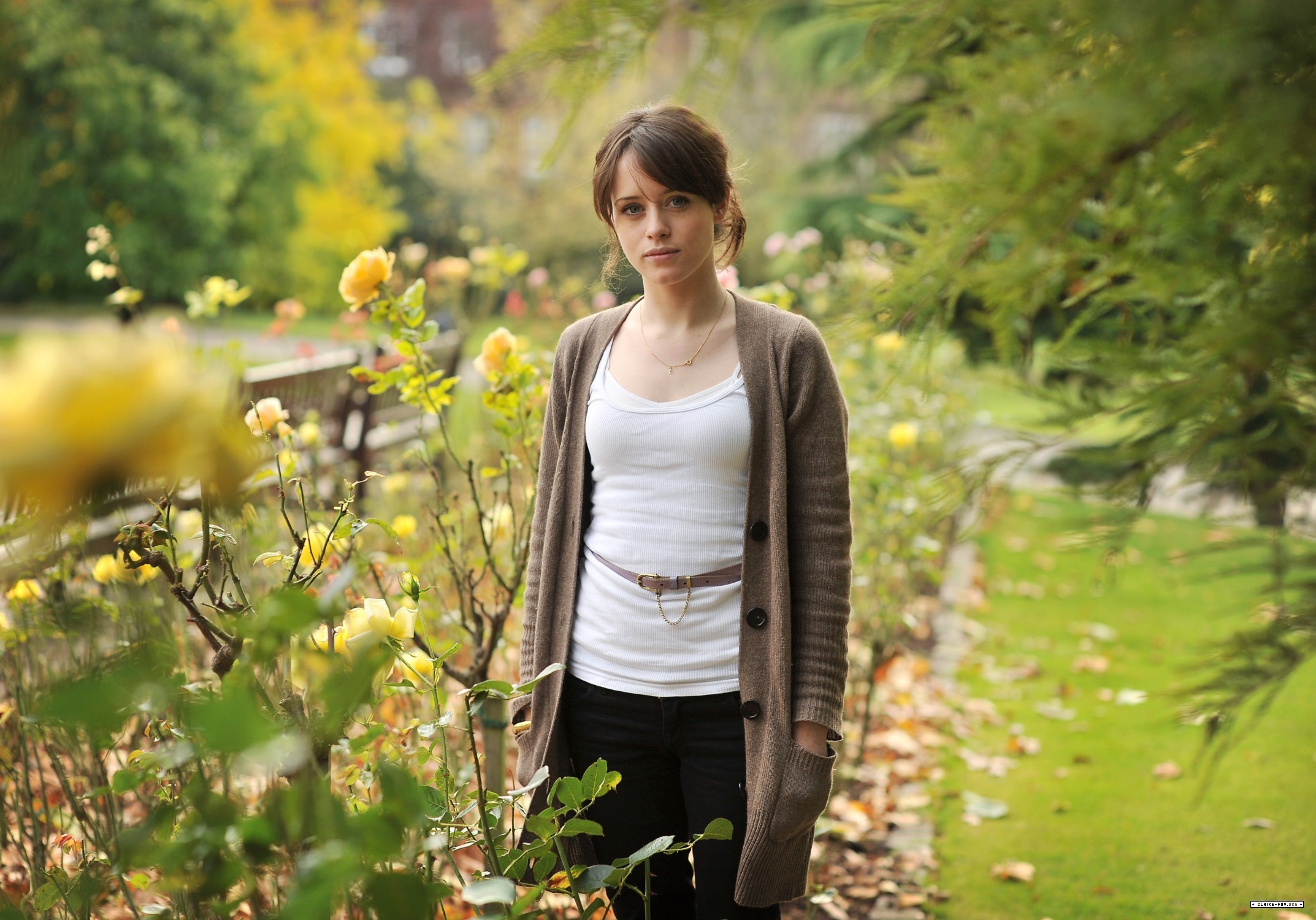 People 2146x1500 women Claire Foy blue eyes grey sweater open sweater actress hands in pockets celebrity women outdoors looking at viewer plants black pants white tops British