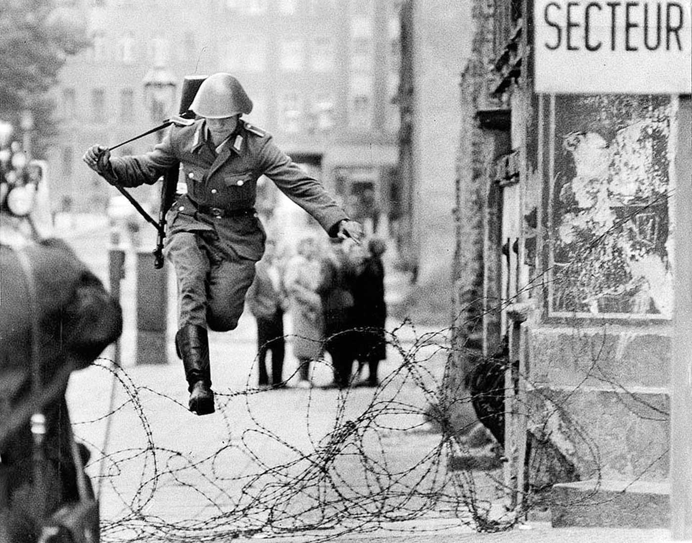 People 1400x1098 East Germany Germany Cold War vintage Berlin soldier jumping monochrome history berlin wall