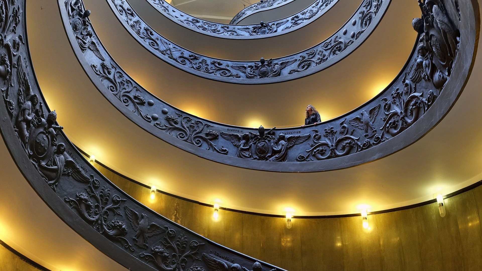 General 1920x1080 architecture indoors stairs Vatican City museum women lights decorations angel coat of arms spiral Rome Italy