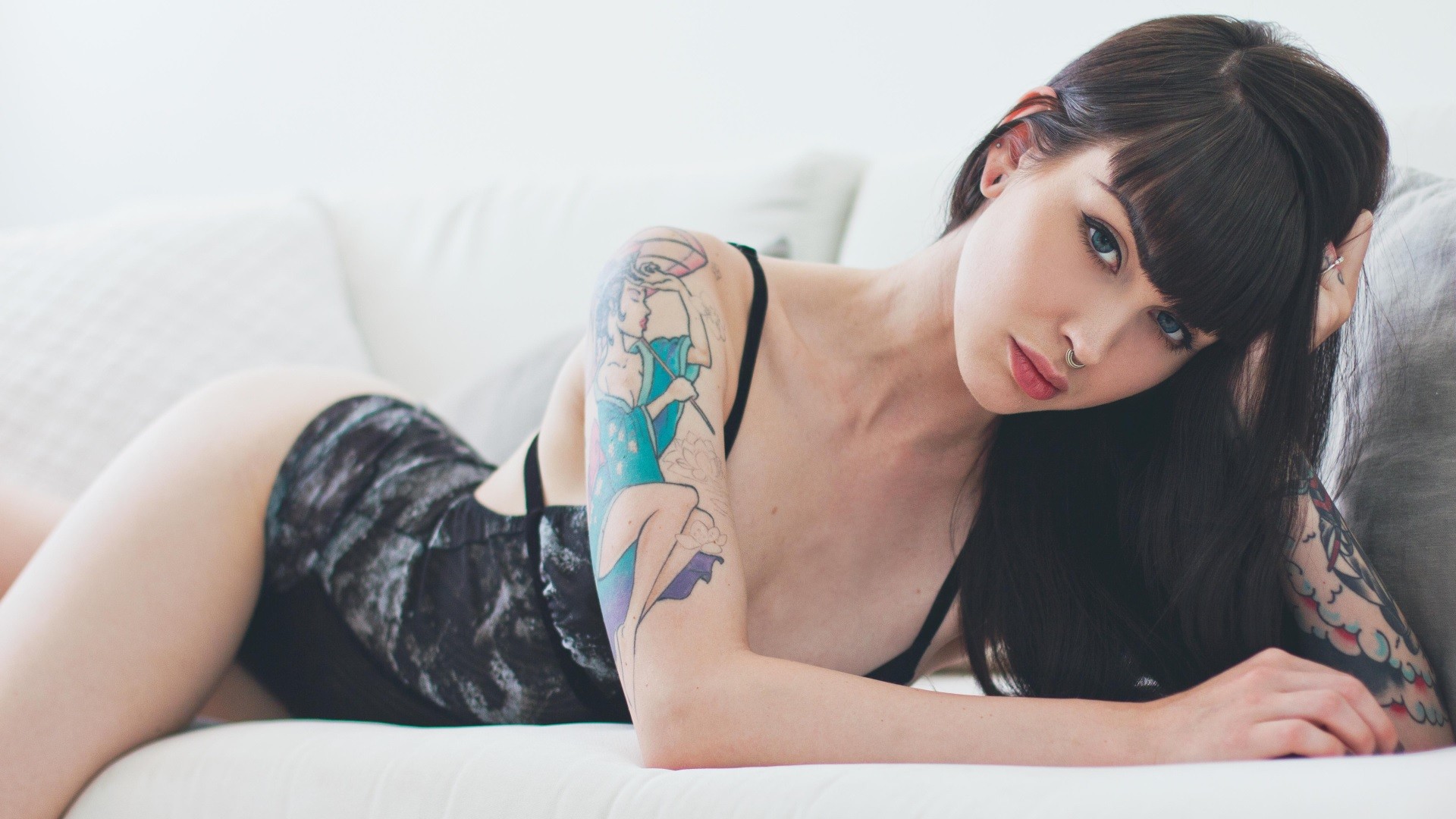 People 1920x1080 black hair tattoo black lingerie contact lenses Suicide Girls Ashley Holat inked girls body lingerie brunette blue eyes women couch pink lipstick face pierced nose lying on front nose ring model septum ring women indoors closeup