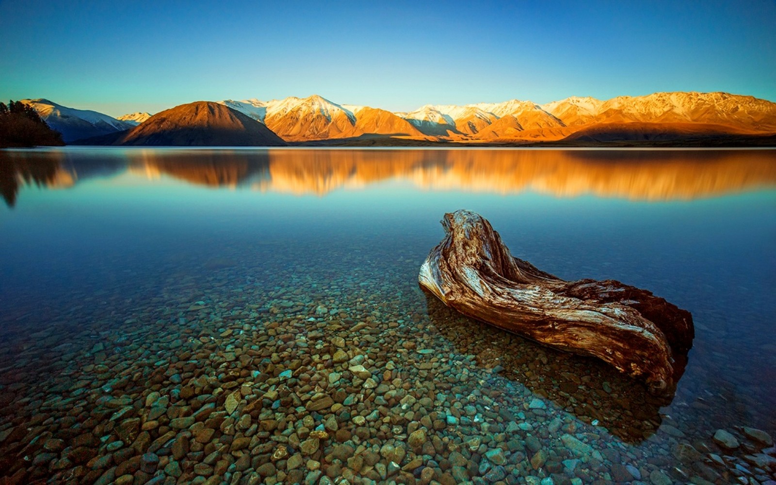 General 1600x1000 nature landscape lake calm mountains water stones snowy peak blue sunset calm waters snowy mountain