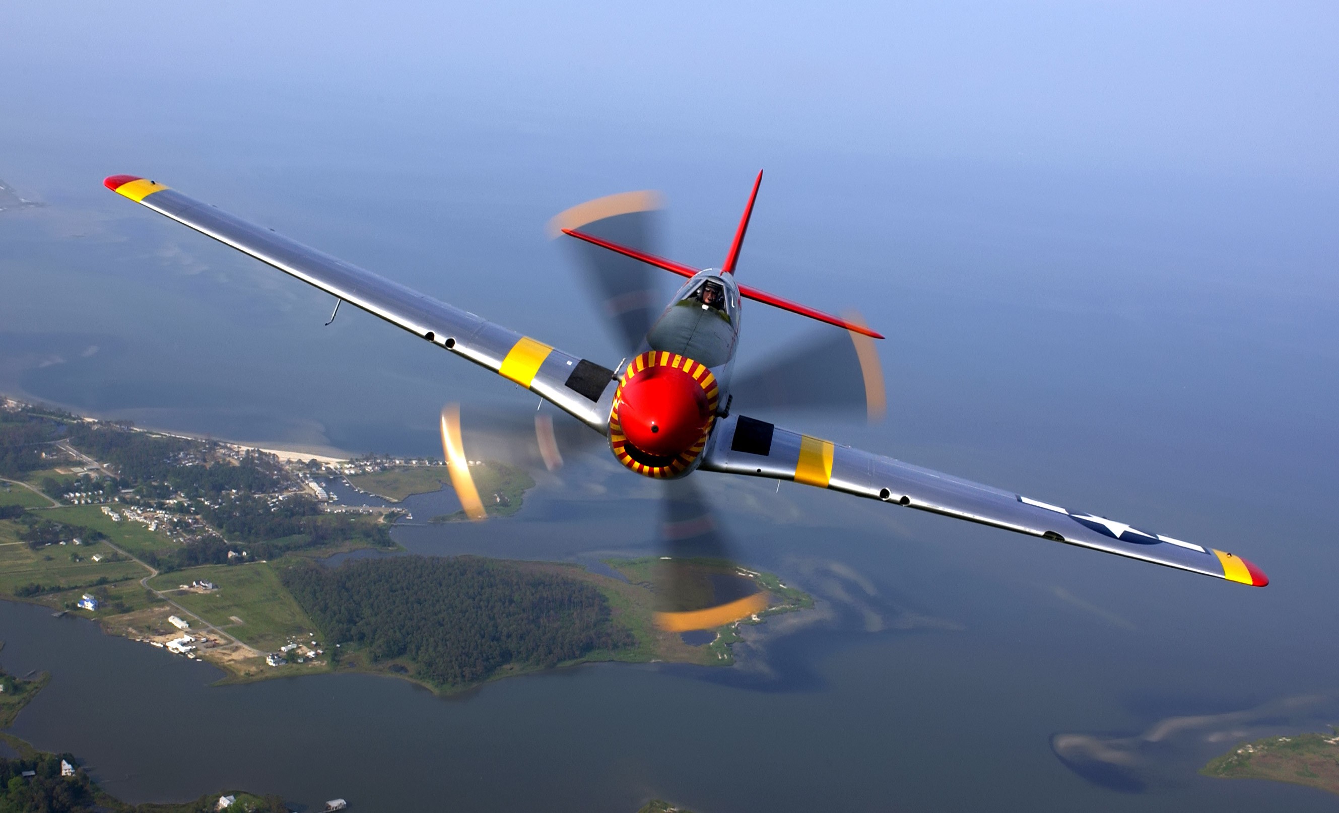General 2658x1614 aerial view airplane men pilot face helmet wings flying motion blur Aviator North American P-51 Mustang American aircraft military aircraft landscape water frontal view sky