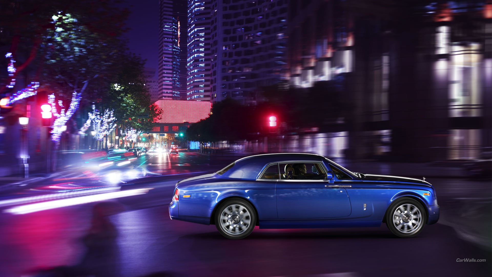 General 1920x1080 Rolls-Royce Phantom car blue cars Rolls-Royce vehicle city lights British cars Grand Tour watermarked side view blurred blurry background driving building city trees street lights street light