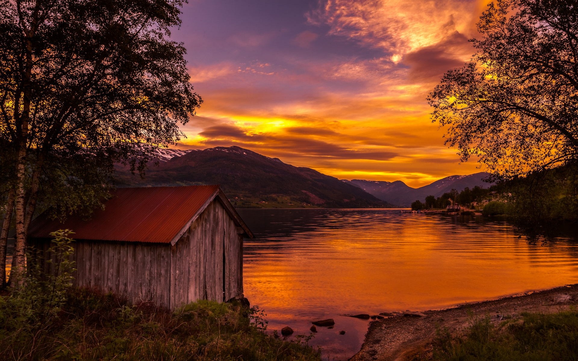 General 1920x1200 nature landscape boathouses lake sunset Norway trees mountains sky clouds shrubs water gold orange sky low light