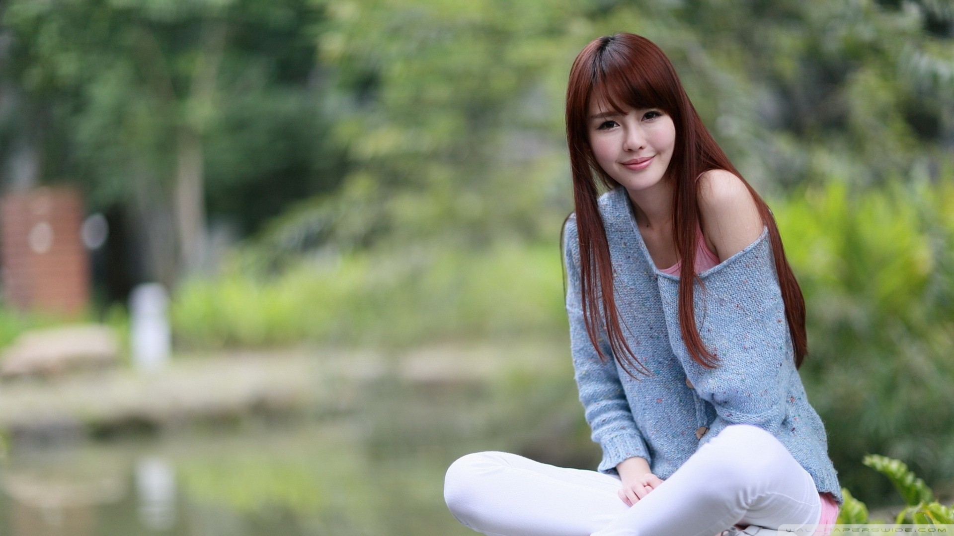 People 1920x1080 women redhead long hair Asian smiling sitting blue sweater women outdoors pink lipstick looking at viewer green background sweater bare shoulders