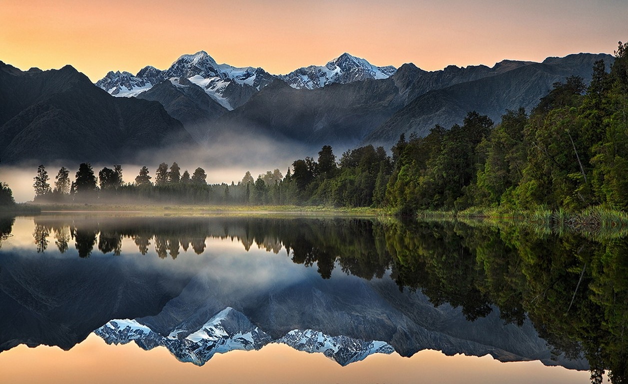 General 1257x768 nature landscape lake reflection mountains forest mist snowy peak water New Zealand trees