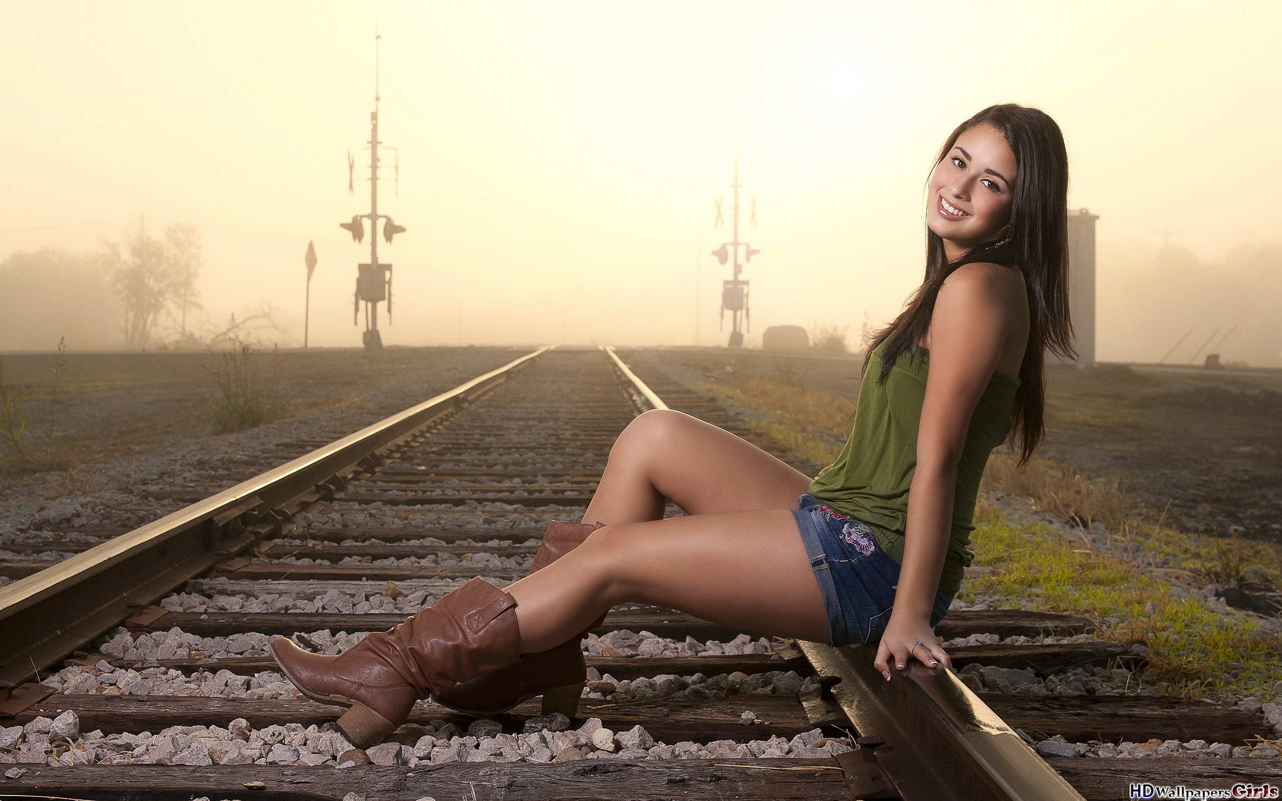 People 2560x1600 women model sitting boots jean shorts rail yard smiling shorts railway looking at viewer legs