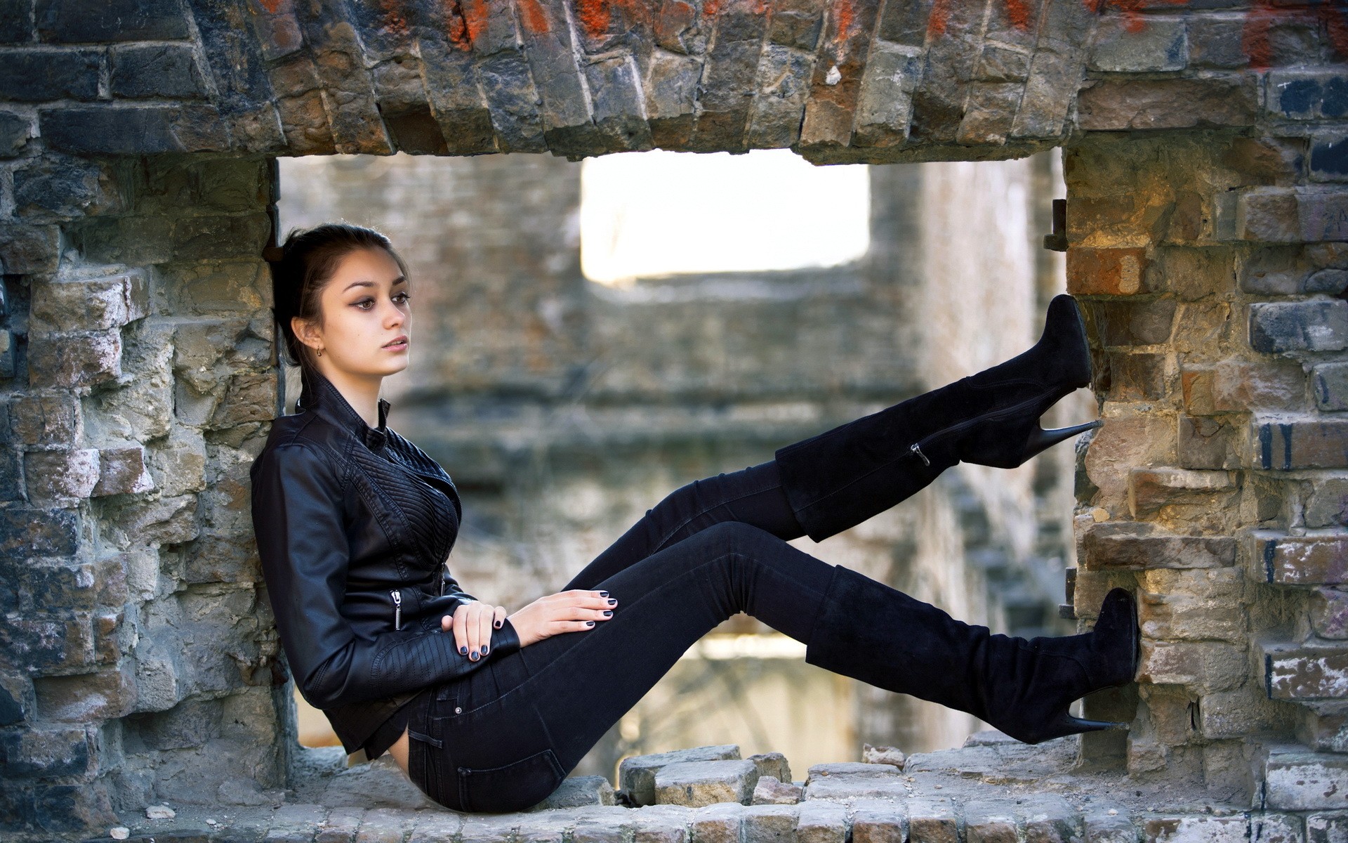 People 1920x1200 women brunette brown eyes leather jacket knee-high boots sitting side view looking into the distance black nails jeans model outdoors wall bricks