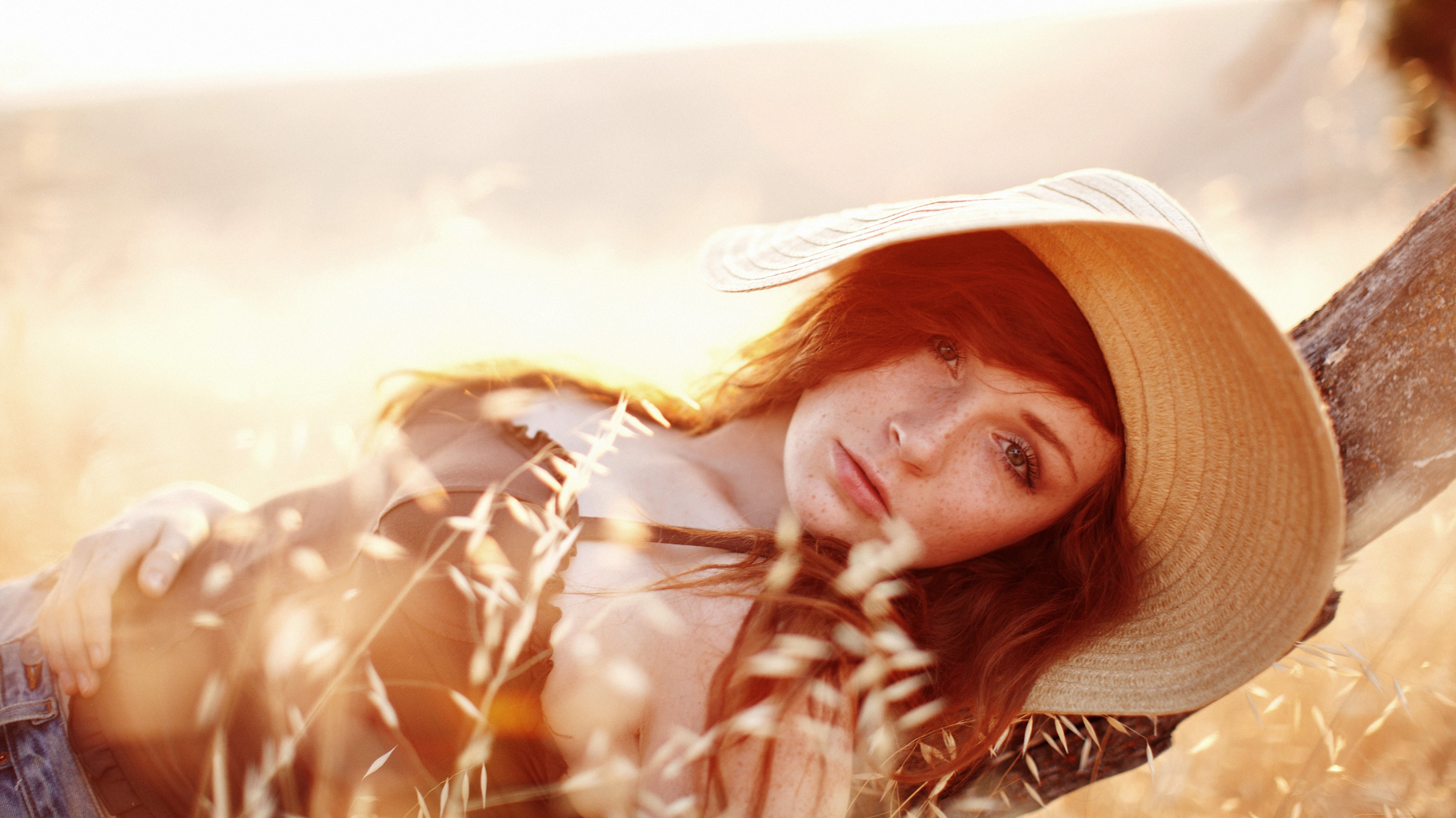 People 5616x3159 redhead hat lying on back women face freckles natural light model women outdoors sunlight women with hats looking at viewer