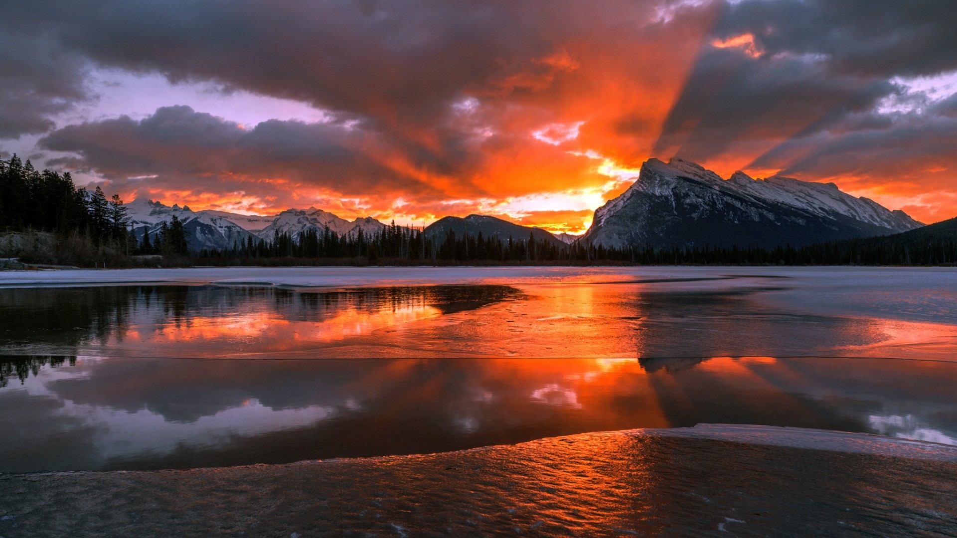 General 1920x1080 nature landscape mountains Canada Alberta snow winter trees forest water lake Sun clouds pine trees frozen lake ice sunset snowy peak reflection orange sky sky
