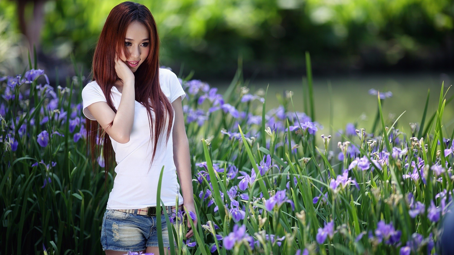 People 1920x1080 women Asian flowers jean shorts model redhead long hair women outdoors nature looking away torn jeans T-shirt smiling plants depth of field belt outdoors standing dyed hair