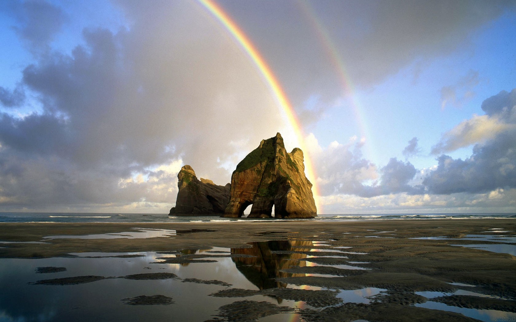 General 1680x1050 landscape rainbows sea rock formation beach New Zealand nature coast rocks sky reflection
