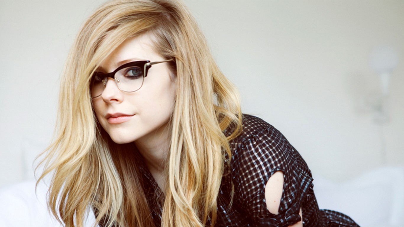 People 1366x768 Avril Lavigne blonde blue eyes glasses face blouses women studio women with glasses singer celebrity looking at viewer long hair