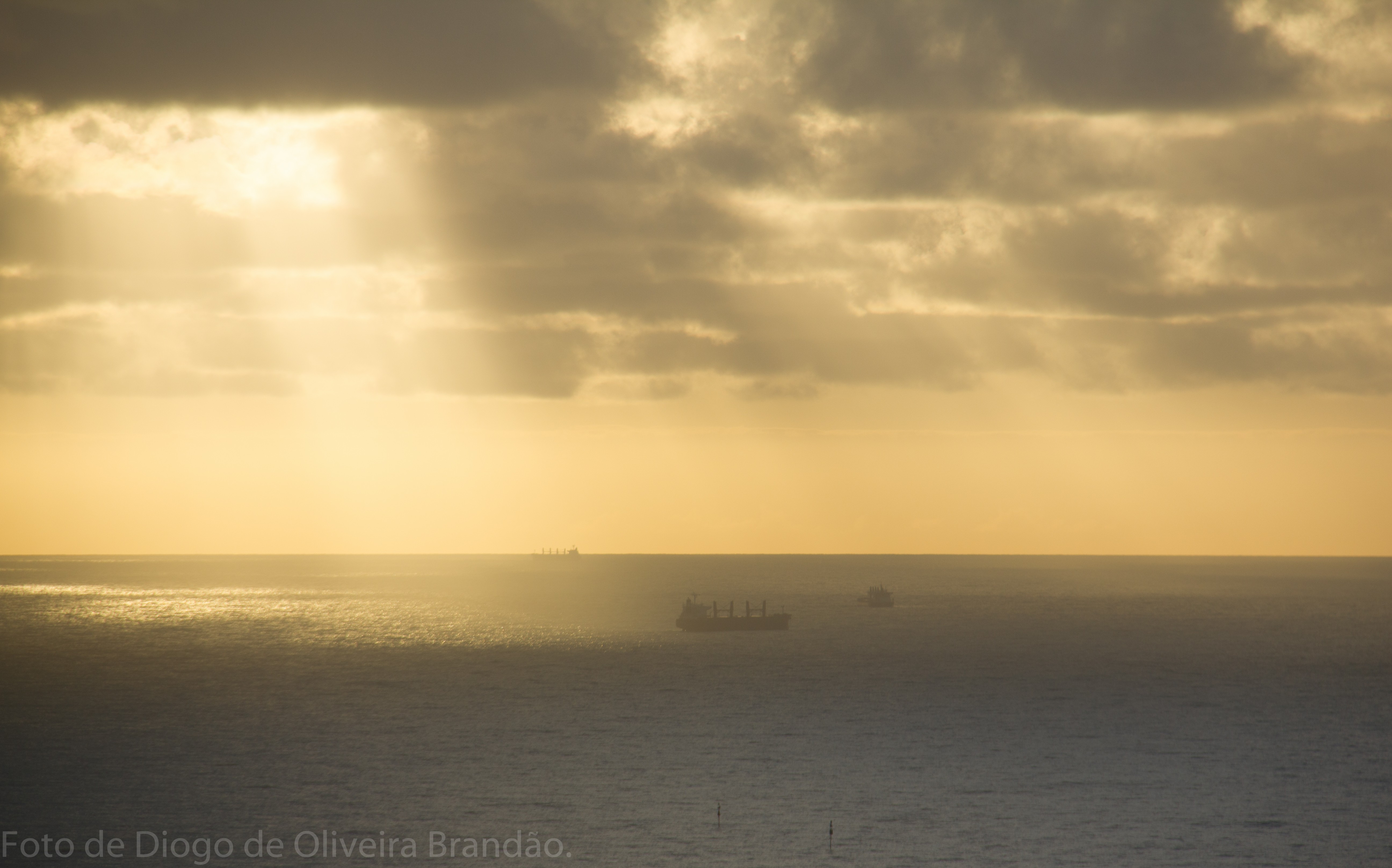 General 5183x3233 sky sea clouds horizon sunlight sunbeams yellow ship low light watermarked