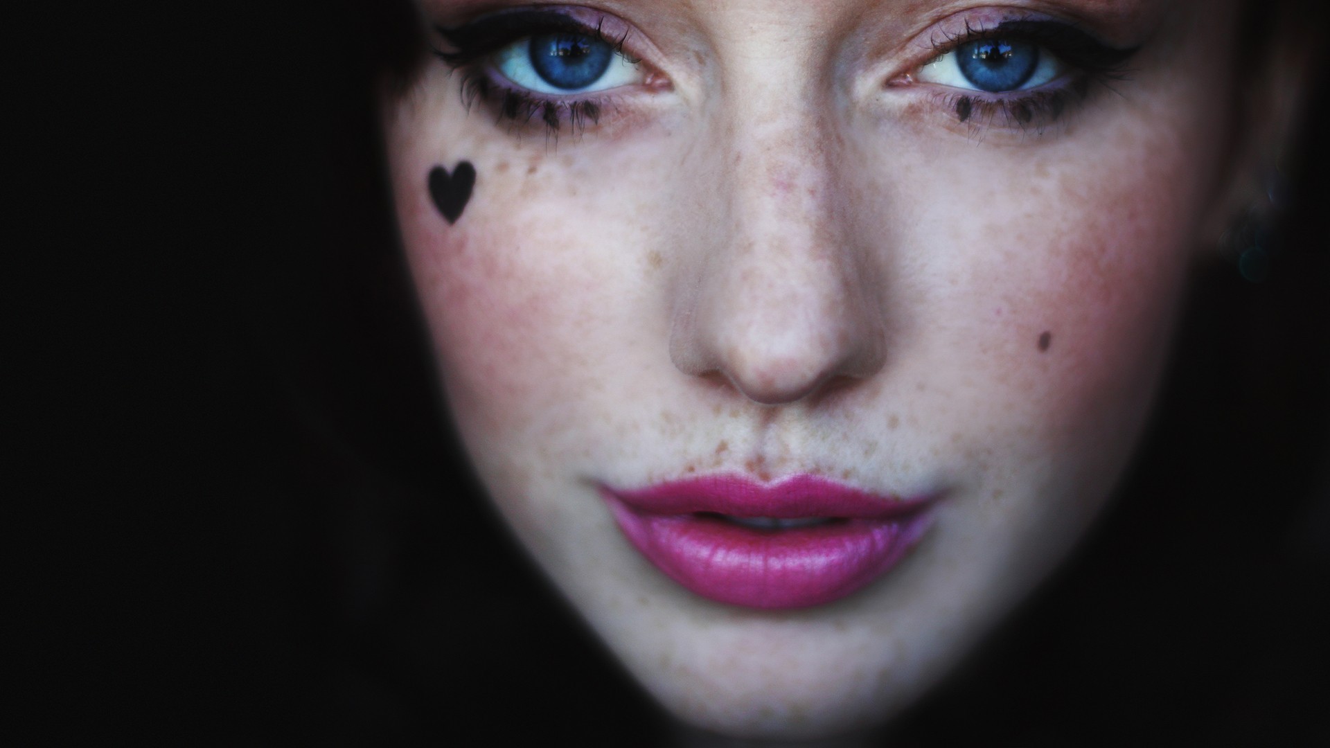 People 1920x1080 face women blue eyes freckles closeup heart (tattoo) looking at viewer pink lipstick simple background black background model portrait